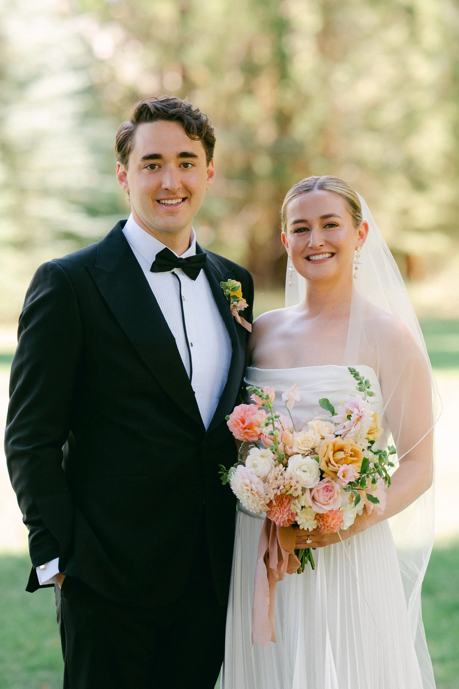 Lake Tahoe 4-H Camp wedding photos, photo of the bride and groom posing for a portrait in a lush, green outdoor setting.