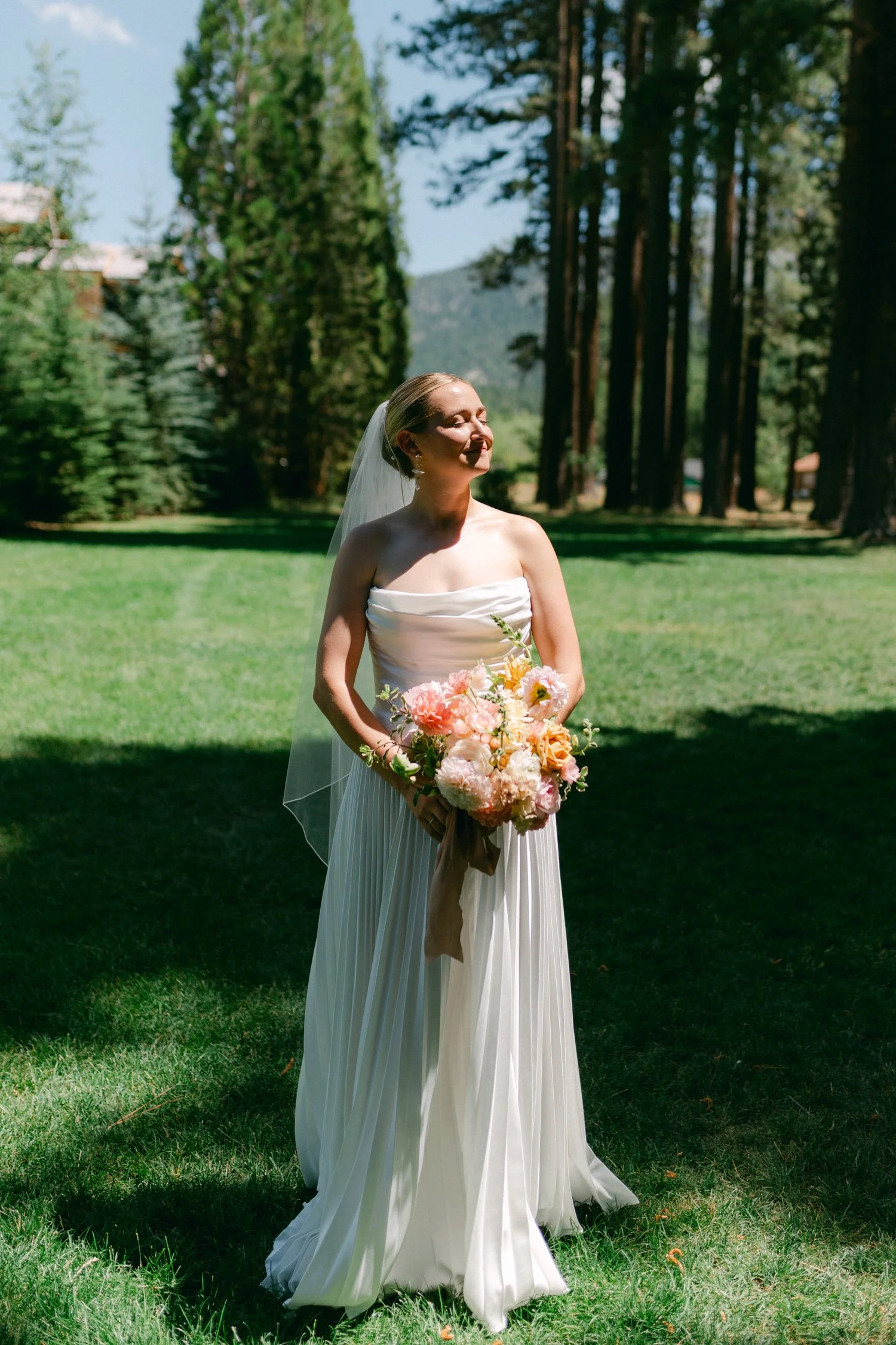 Lake Tahoe 4-H Camp wedding photos, photo of the bride in her romantic wedding gown with a ruched corset bodice and a pleated A-line skirt