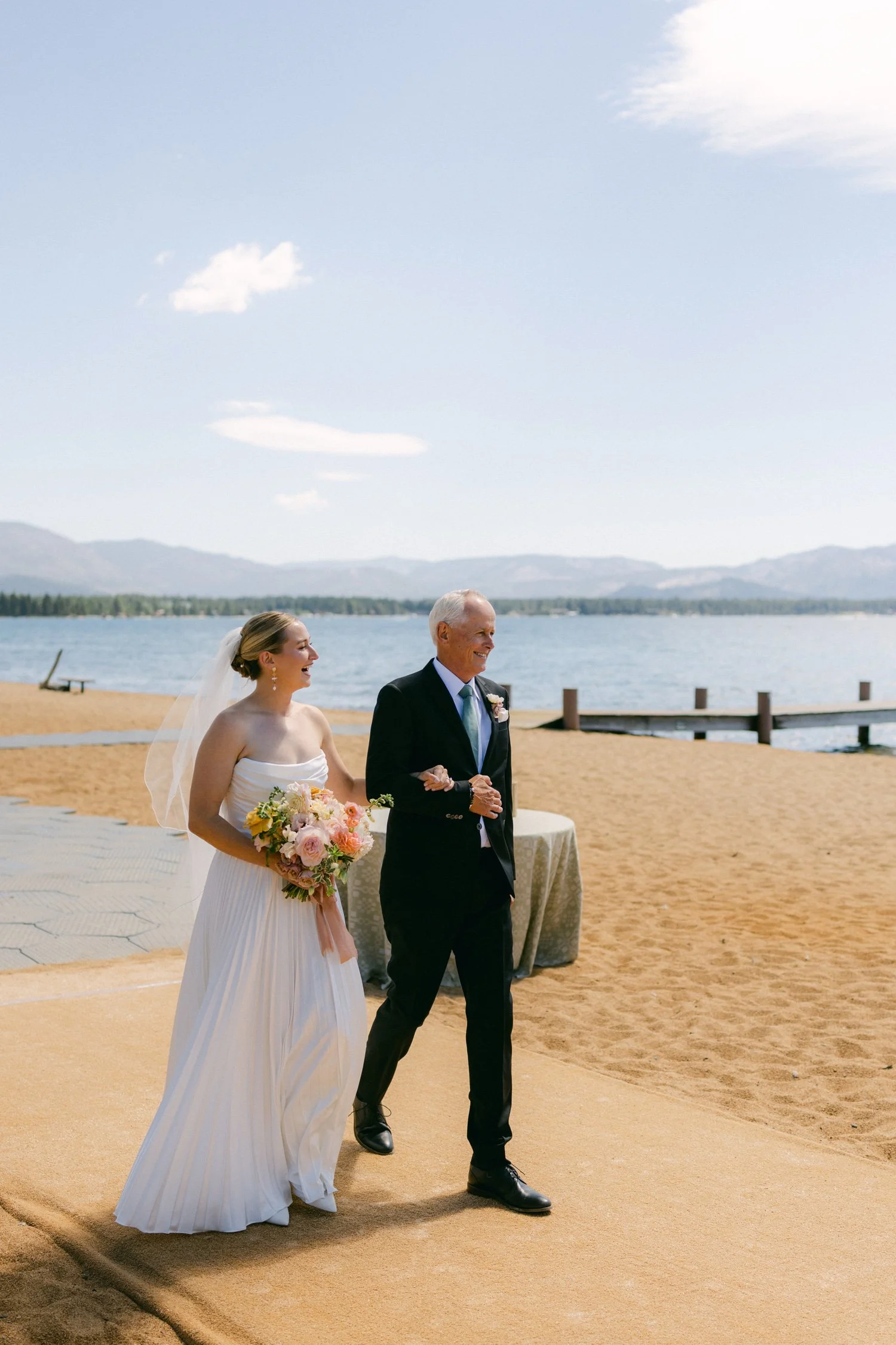 Lake Tahoe 4-H Camp wedding photos, photo of the bride walking down the aisle with breathtaking mountain backdrops.