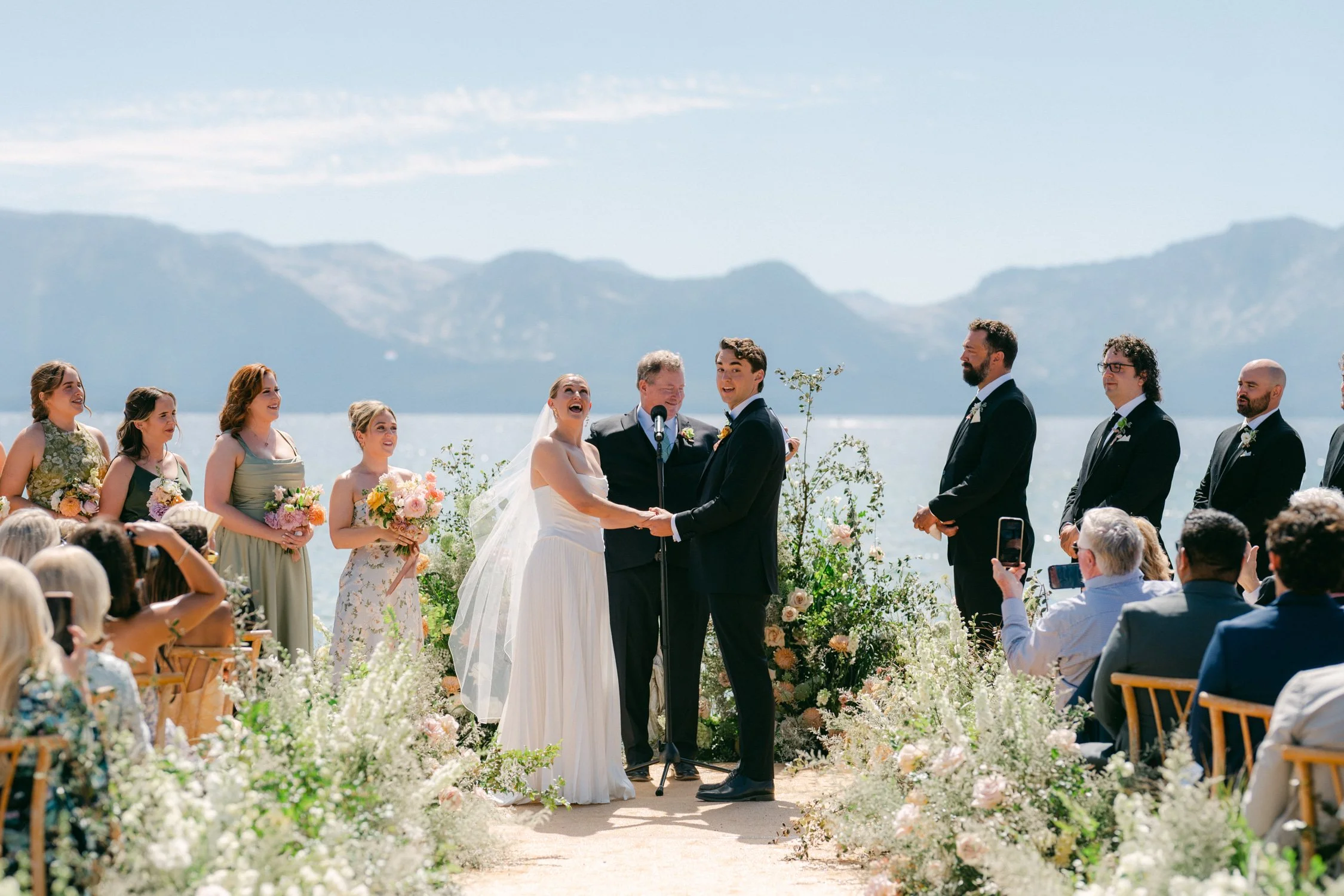 Lake Tahoe 4-H Camp wedding photos, photo of the ceremony setup features minimal floral decor designed to frame the couple against the lake and mountain backdrop.