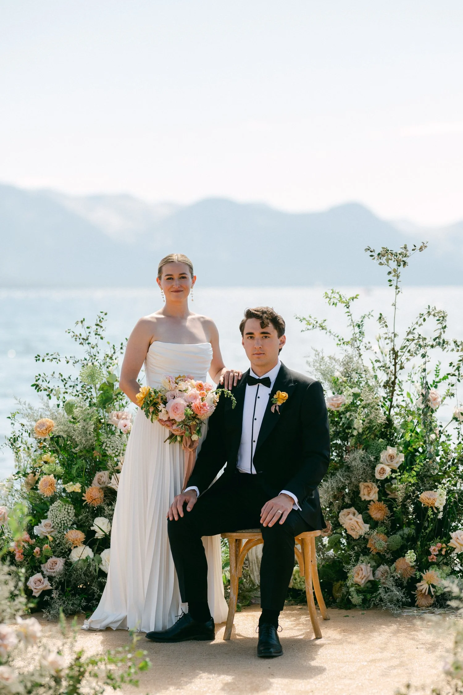 Lake Tahoe 4-H Camp wedding photos, photo of the bride in a strapless gown and the groom in a classic tuxedo against a scenic backdrop 