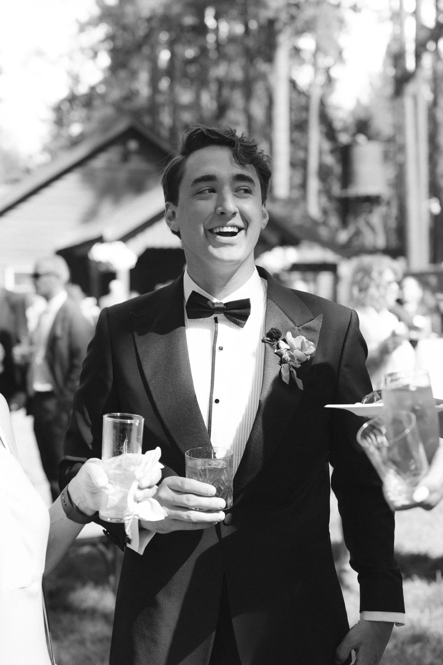 Lake Tahoe 4-H Camp wedding photos, photo of the groom in a black tuxedo enjoying the cocktail hour