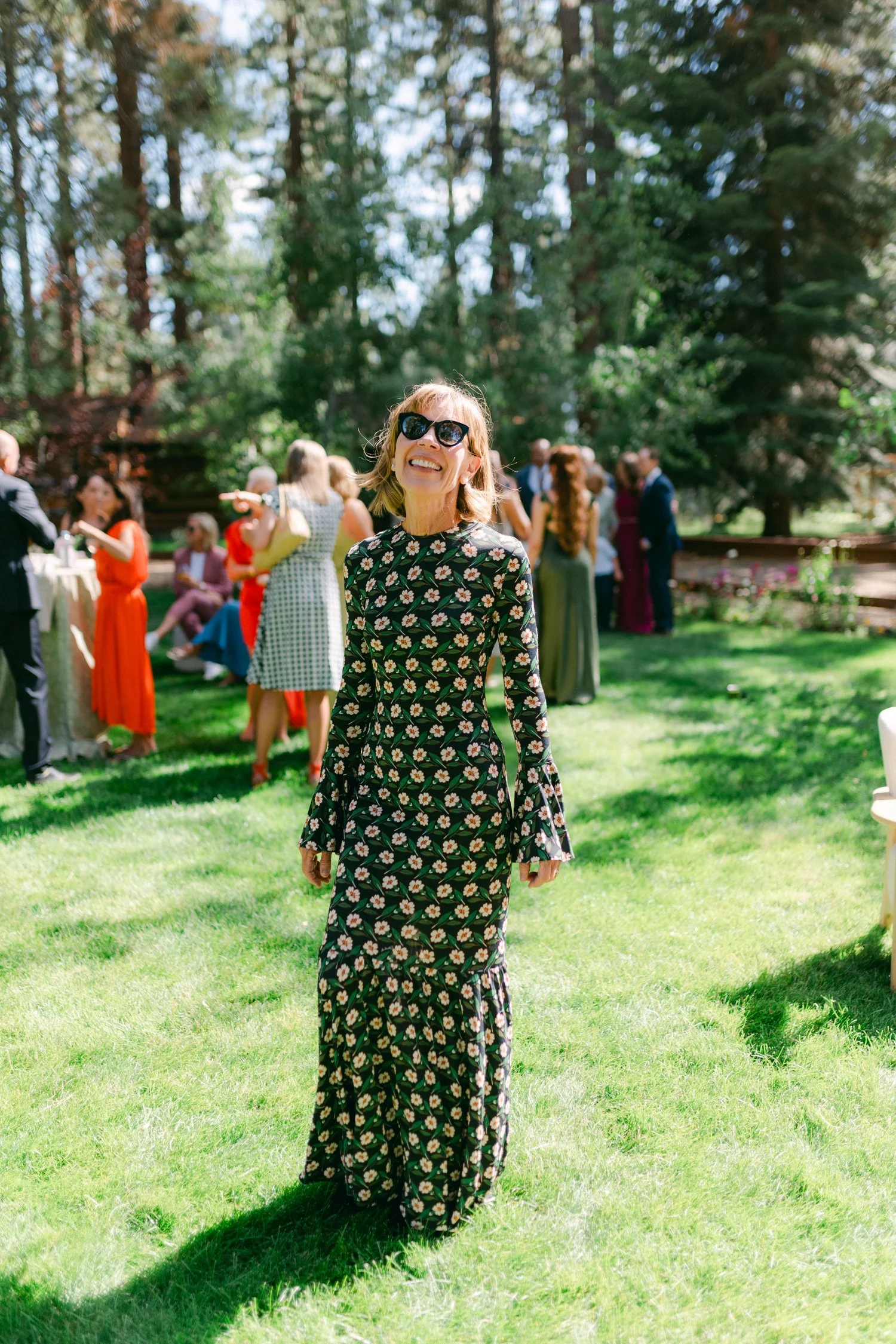Lake Tahoe 4-H Camp wedding photos, photo of stylish guest in a floral print and flared cuffs dress