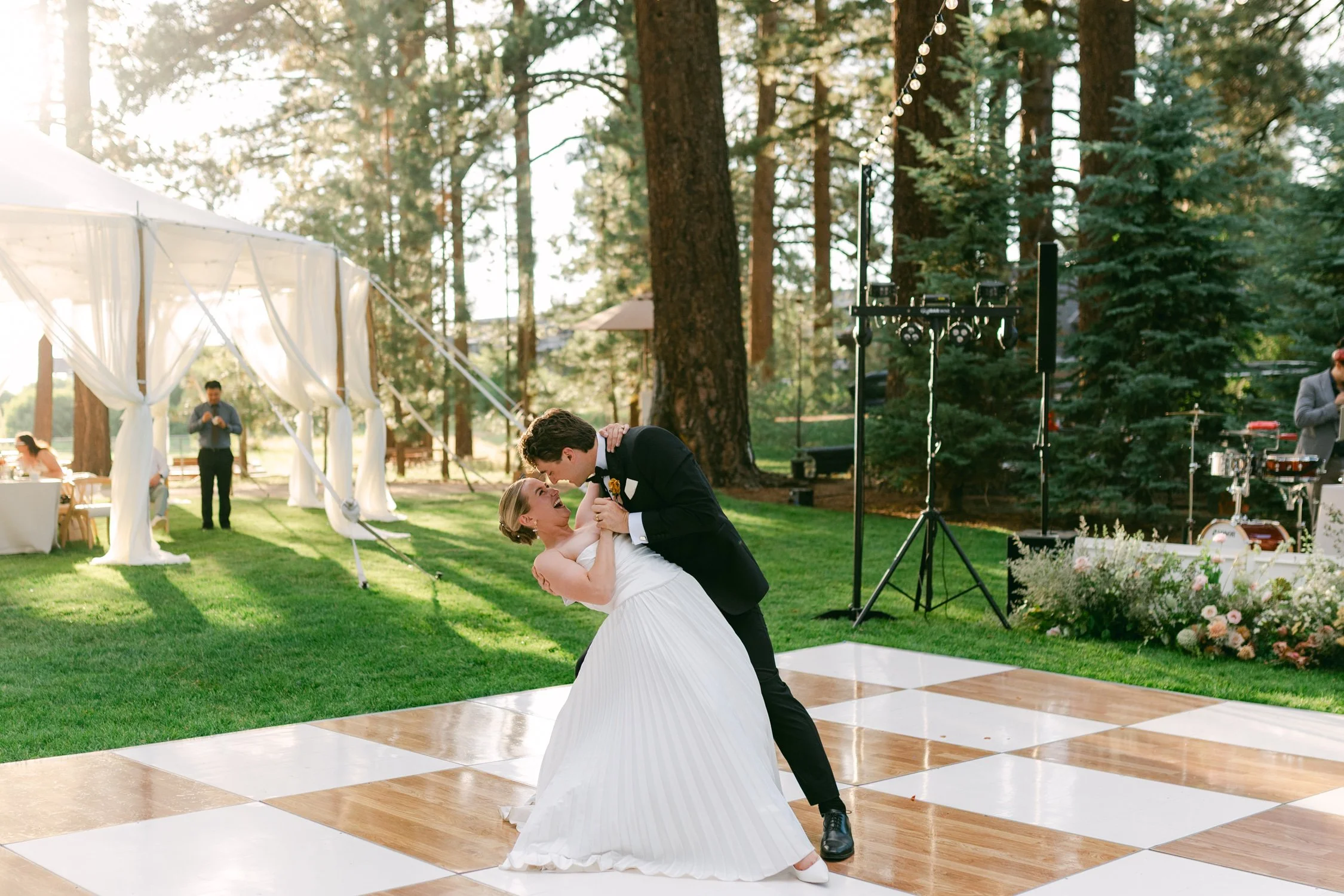 Lake Tahoe 4-H Camp wedding photos, photo of the couple's first dance surrounded by trees at an outdoor wedding setting