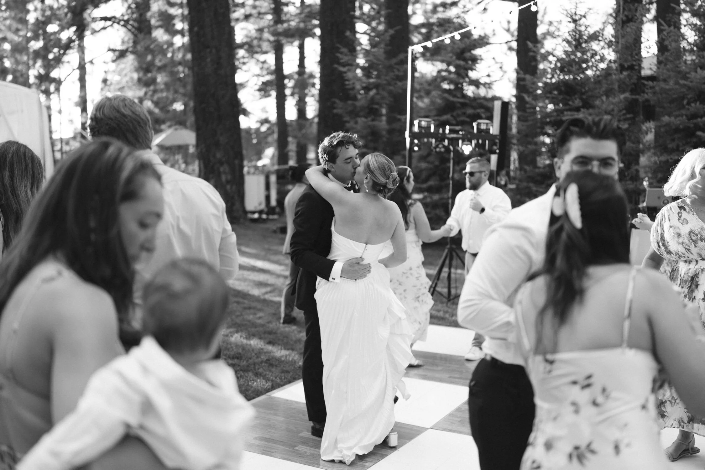 Lake Tahoe 4-H Camp wedding photos, photo of a couple sharing a dance at an outdoor wedding celebration surrounded by their guests 