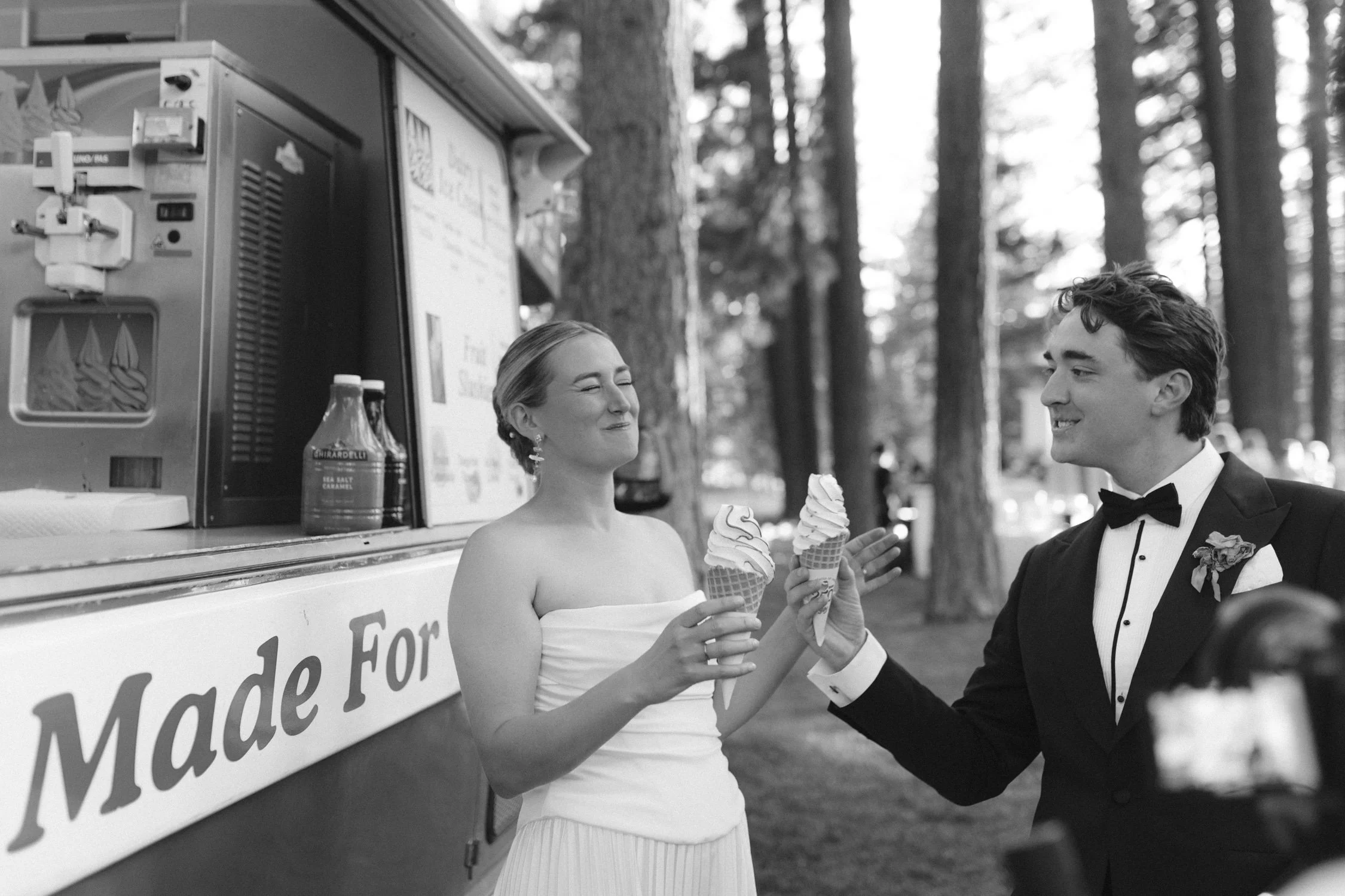 Lake Tahoe 4-H Camp wedding photos, photo of the couple smiling at each other while holding ice cream cones in front of a mobile food truck
