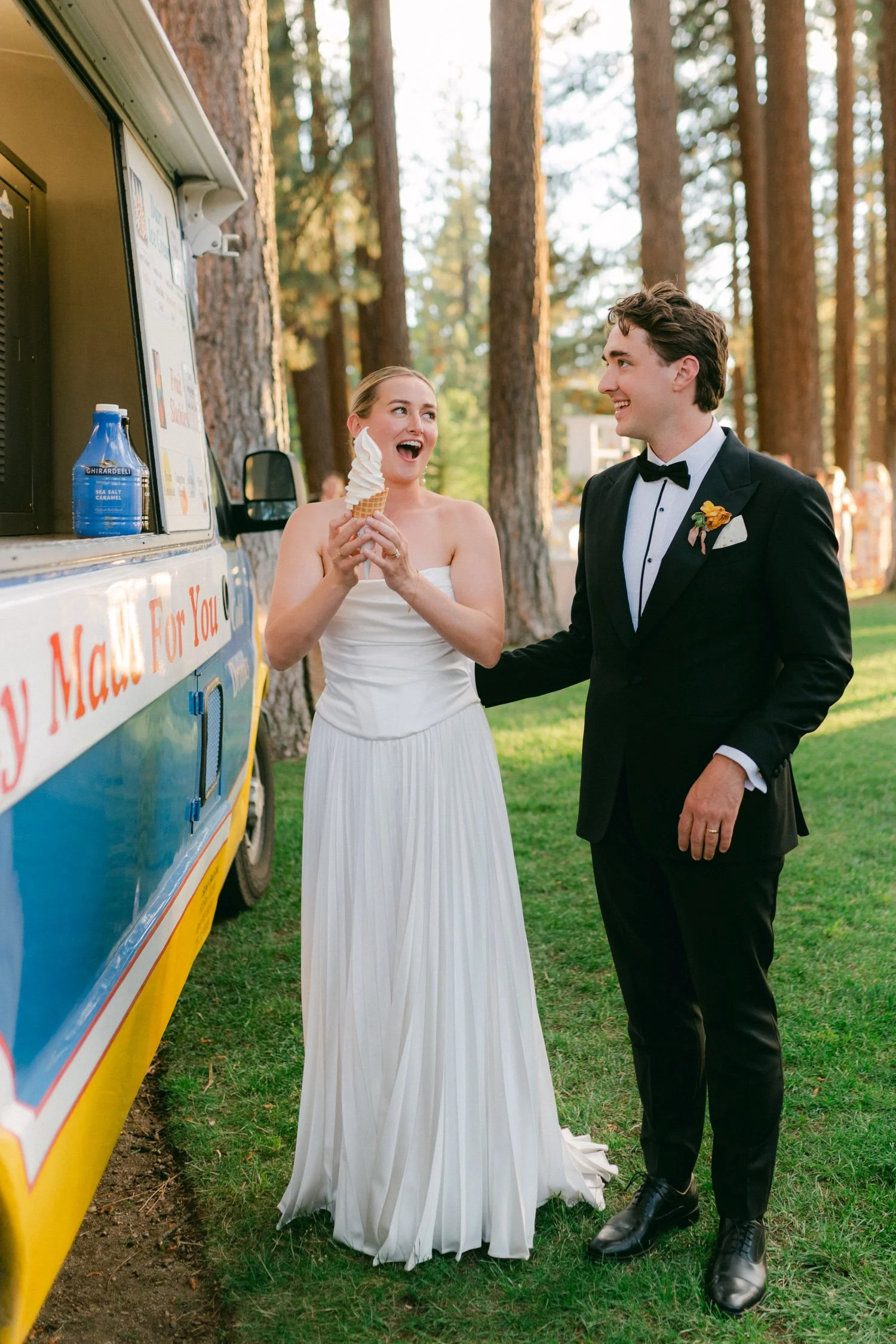 Lake Tahoe 4-H Camp wedding photos, photo of the newlywed couple enjoying a moment together at their wedding with a classic ice cream truck