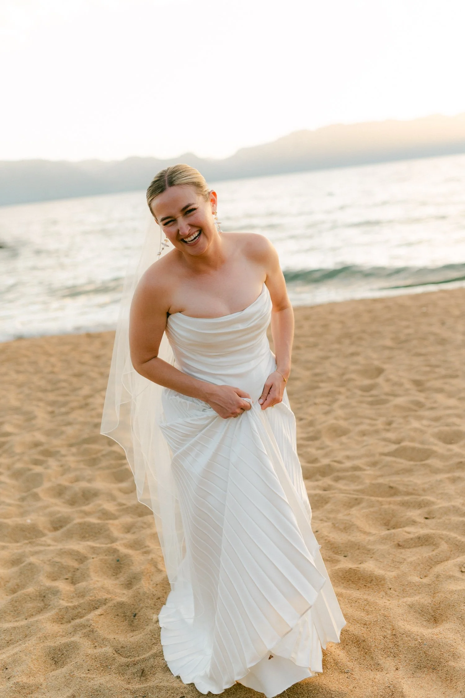 Lake Tahoe 4-H Camp wedding photos, photo of the bride in a strapless gown featuring delicate pleated silk-wool fabric and a dipped neckline