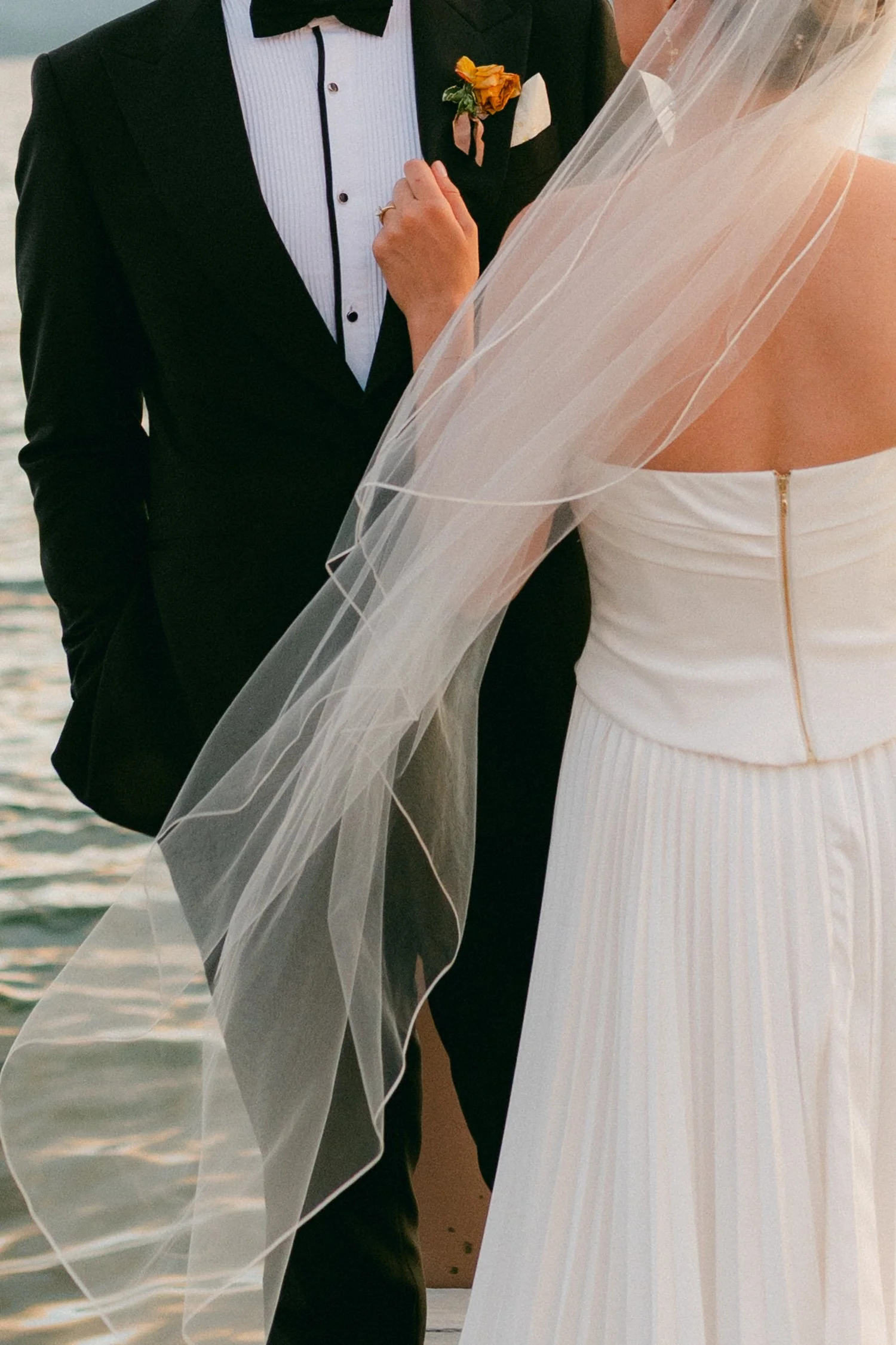 Lake Tahoe 4-H Camp wedding photos, photo of the groom in a classic black tuxedo and the bride in a pleated white bridal gown and a sheer veil.
