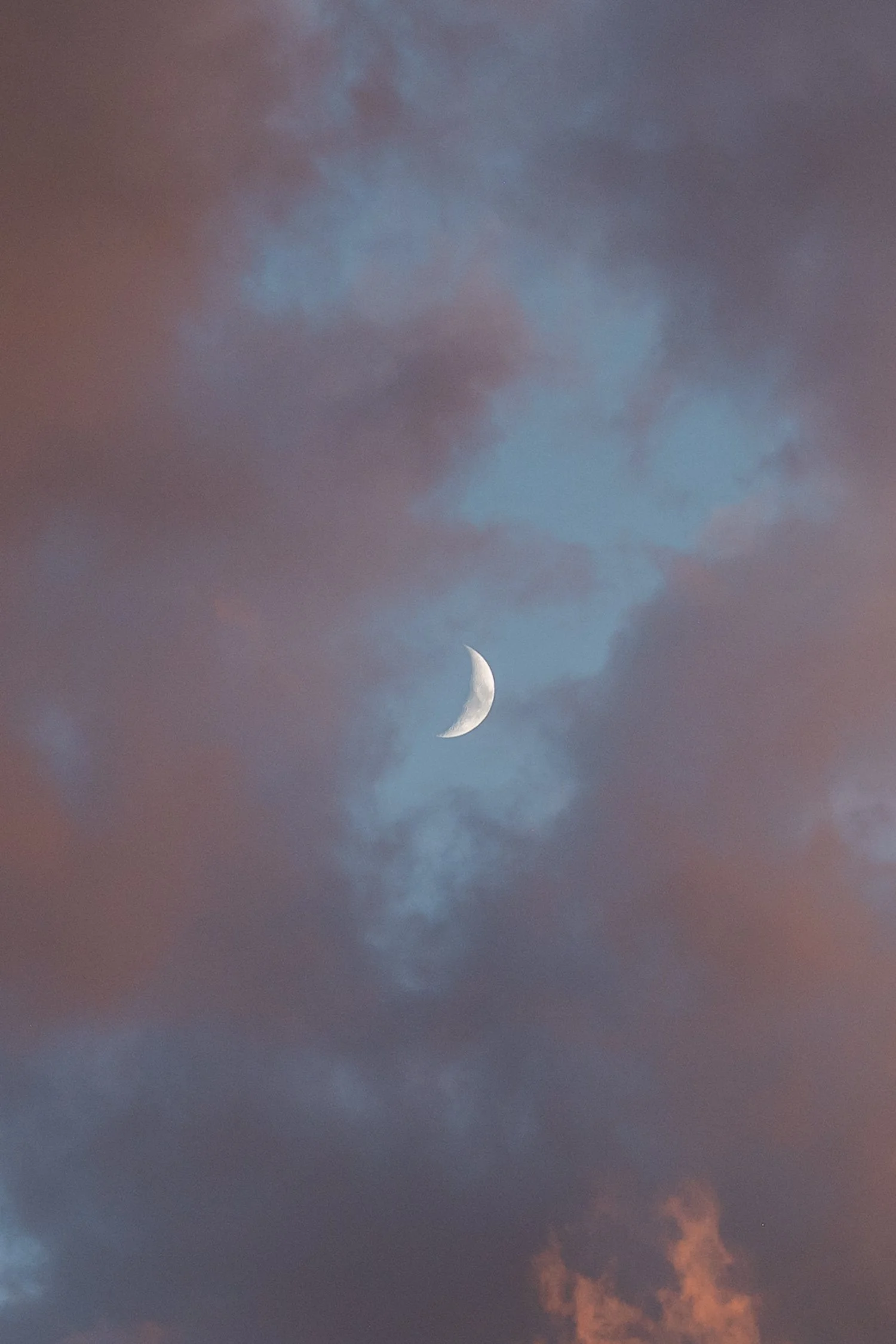 Lake Tahoe 4-H Camp wedding photos, photo of a crescent moon visible through thick, sunset clouds.