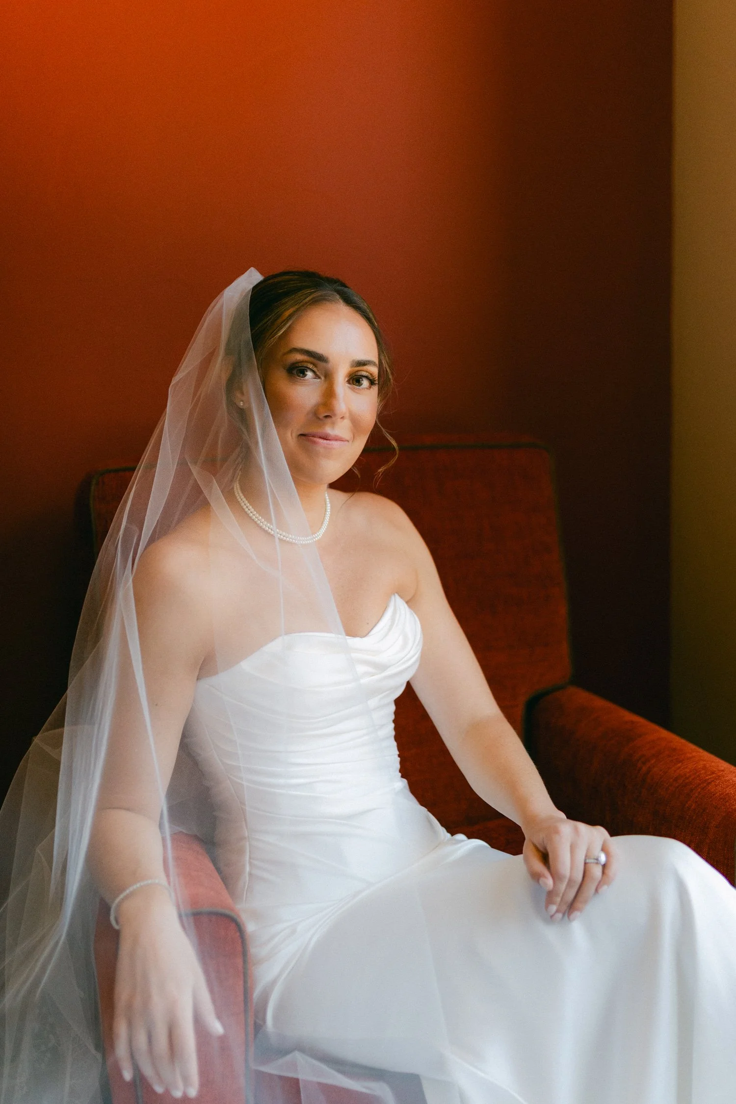 Zephyr Lodge wedding, photo of the bride in a strapless white wedding dress with a ruched satin bodice and a flowing sheer veil