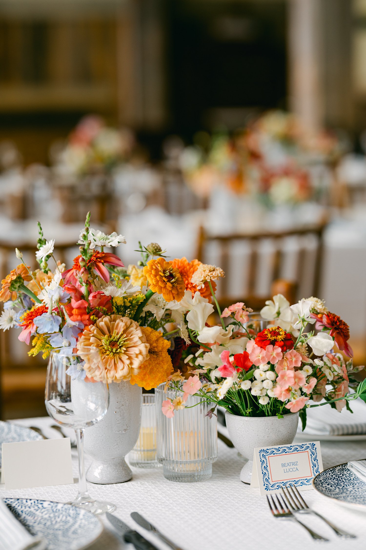 Zephyr Lodge wedding, photo of a vibrant wedding centerpiece arranged in a rustic, textured white vase
