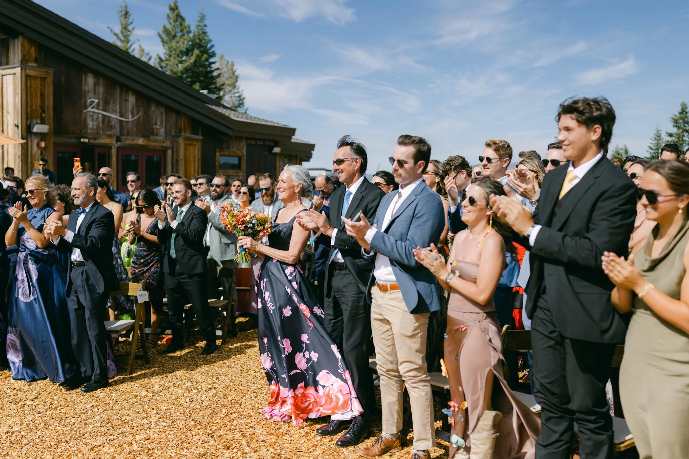 Zephyr Lodge wedding, photo of the wedding guests cheering for the newlyweds at an outdoor wedding venue
