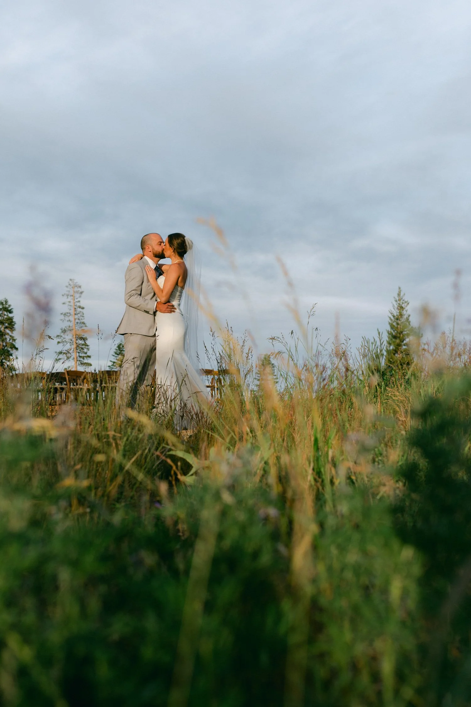Zephyr Lodge wedding, photo of a newlywed couple sharing a moment during a golden hour photo session in a field