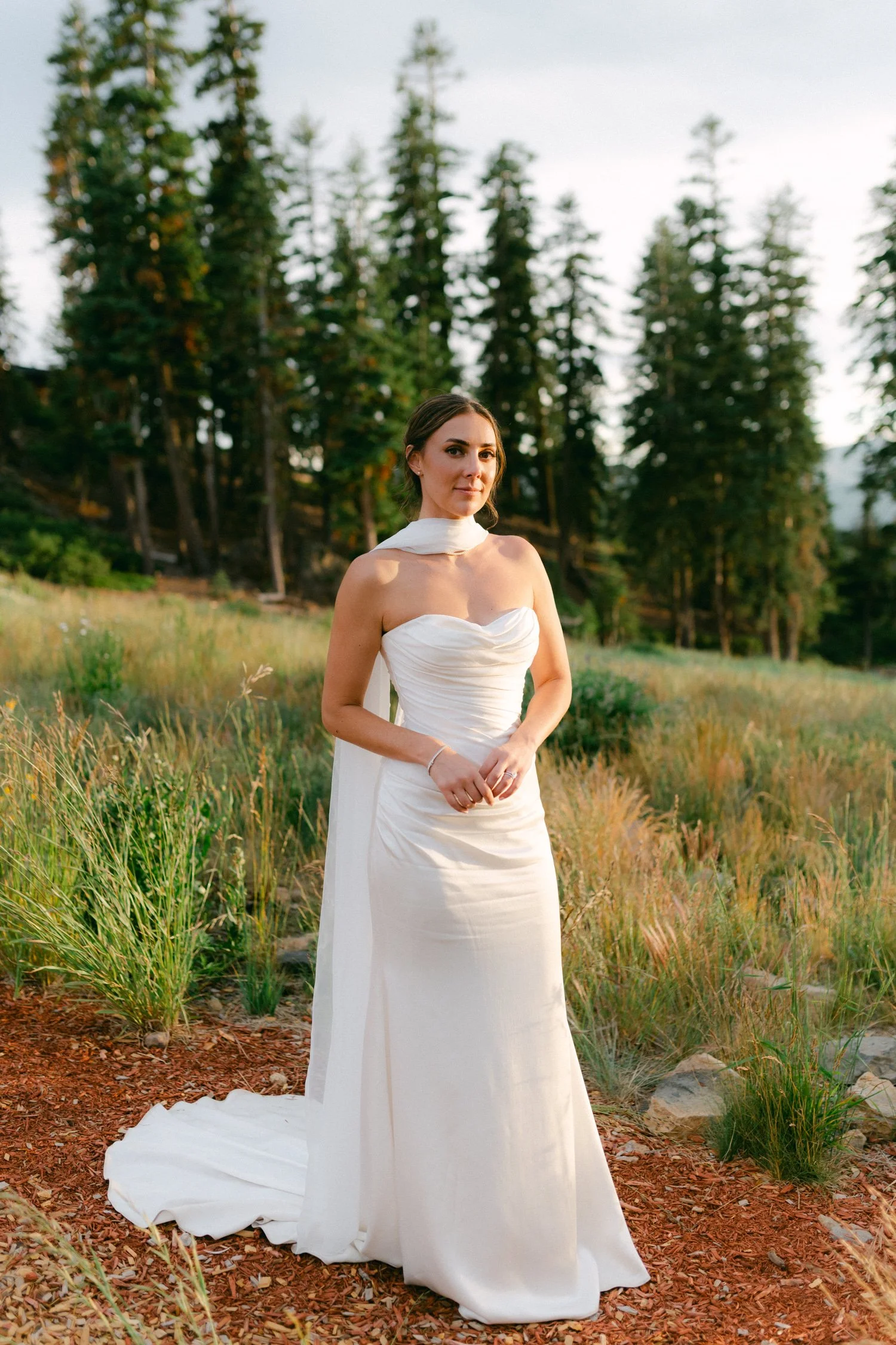 Zephyr Lodge wedding, photo of the bride in a wedding dress featuring a structured, strapless bodice and a flowing matching neck scarf