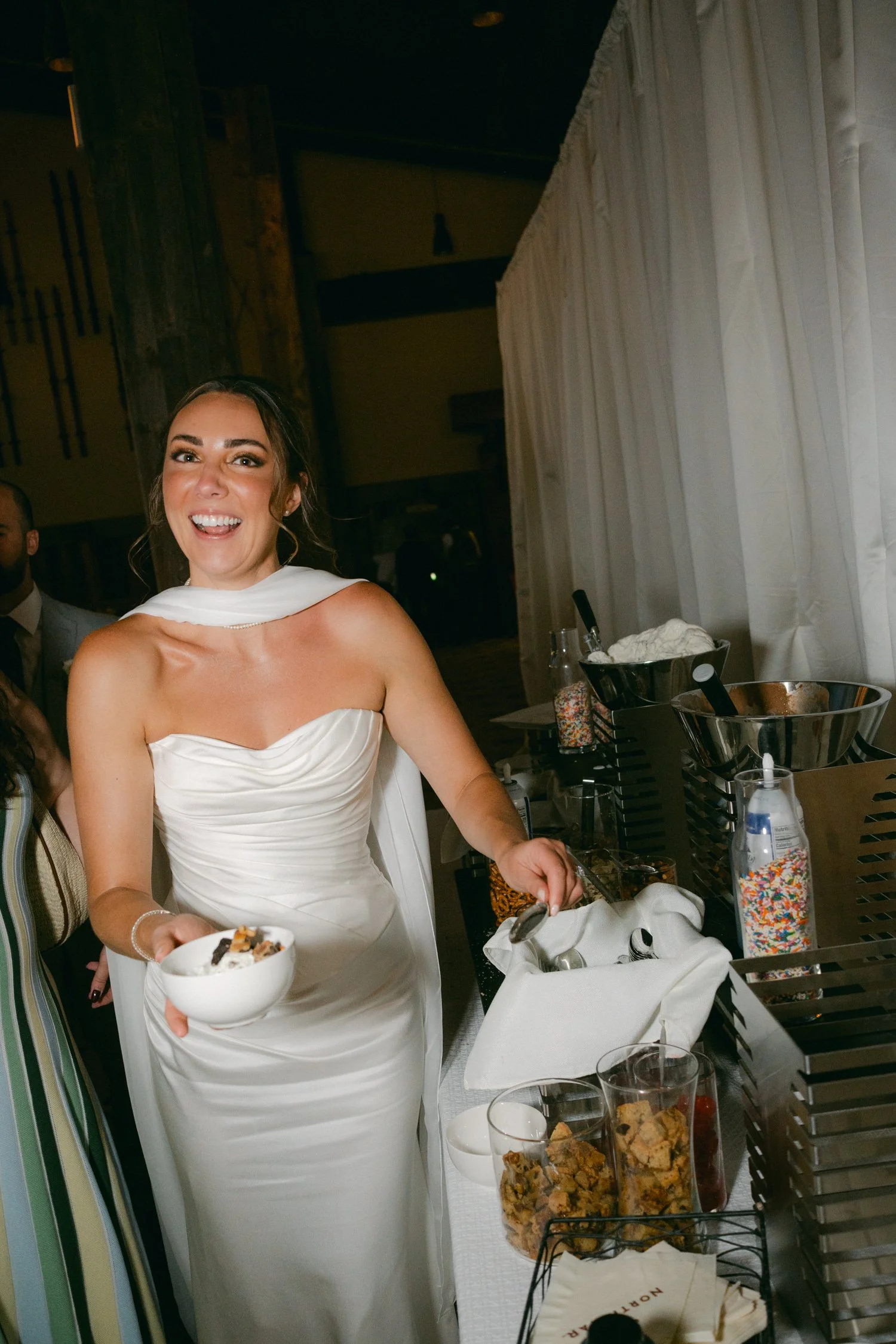 Zephyr Lodge wedding, photo of the bride smiling at the dessert station