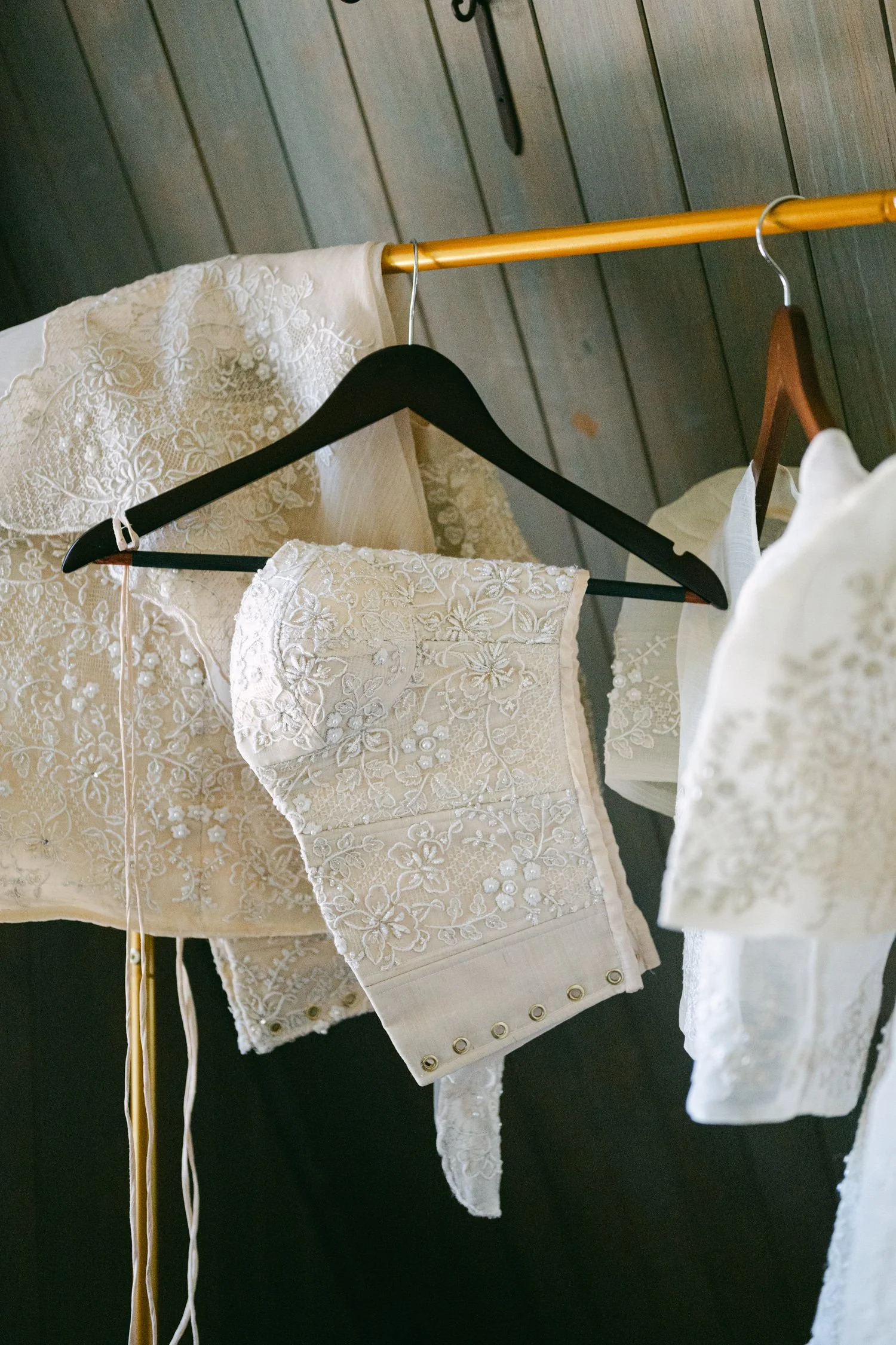 A Valhalla Lake Tahoe Wedding, photo of a beautifully embroidered, traditional Filipiniana bridal corset and matching separates hanging on a rack.