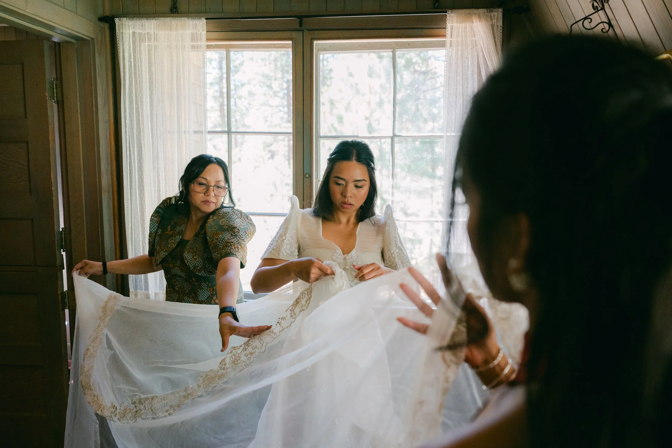 A Valhalla Lake Tahoe Wedding, photo of a bride wearing a traditional Filipiniana-style wedding gown with butterfly sleeves during wedding preparations