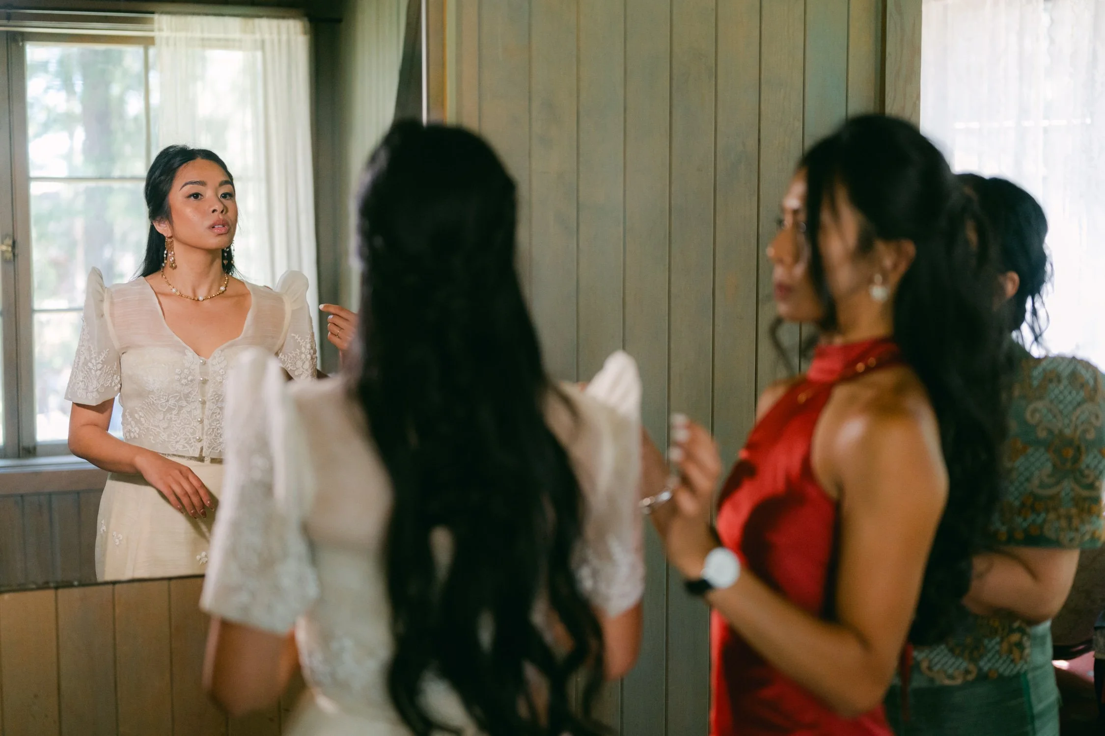 A Valhalla Lake Tahoe Wedding, photo of the bride wearing a modern Filipiniana gown with signature butterfly sleeves getting ready for the ceremony