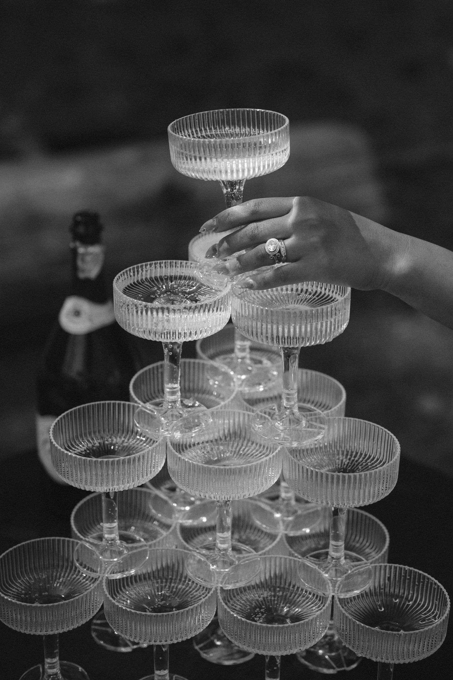 A Valhalla Lake Tahoe Wedding, photo of a champagne tower featuring stacked, ribbed coupe glasses being poured at a celebration