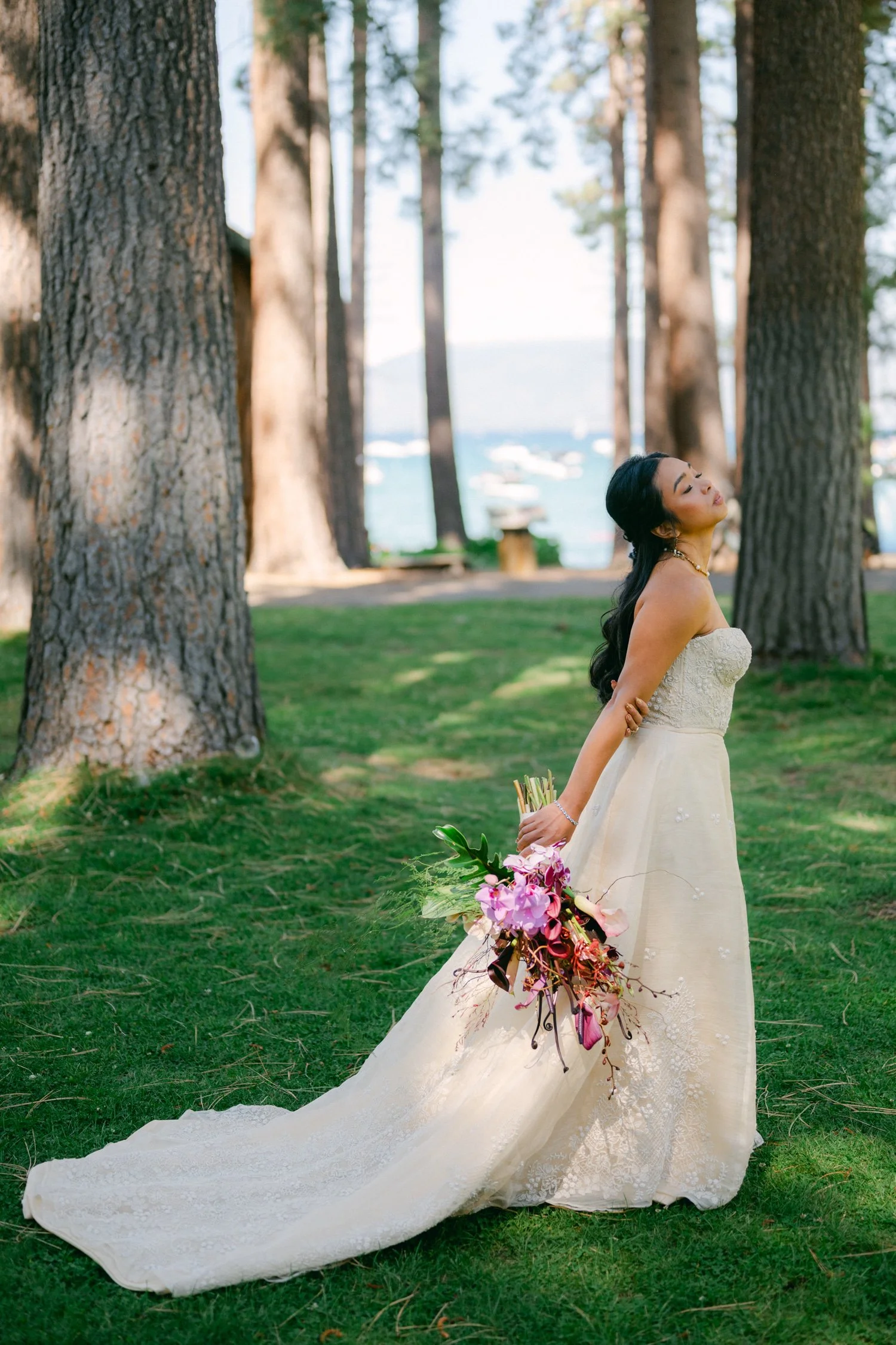 A Valhalla Lake Tahoe Wedding, photo of an outdoor bridal portrait featuring a strapless A-line wedding gown with textured floral embroidery and a colorful cascading bouquet