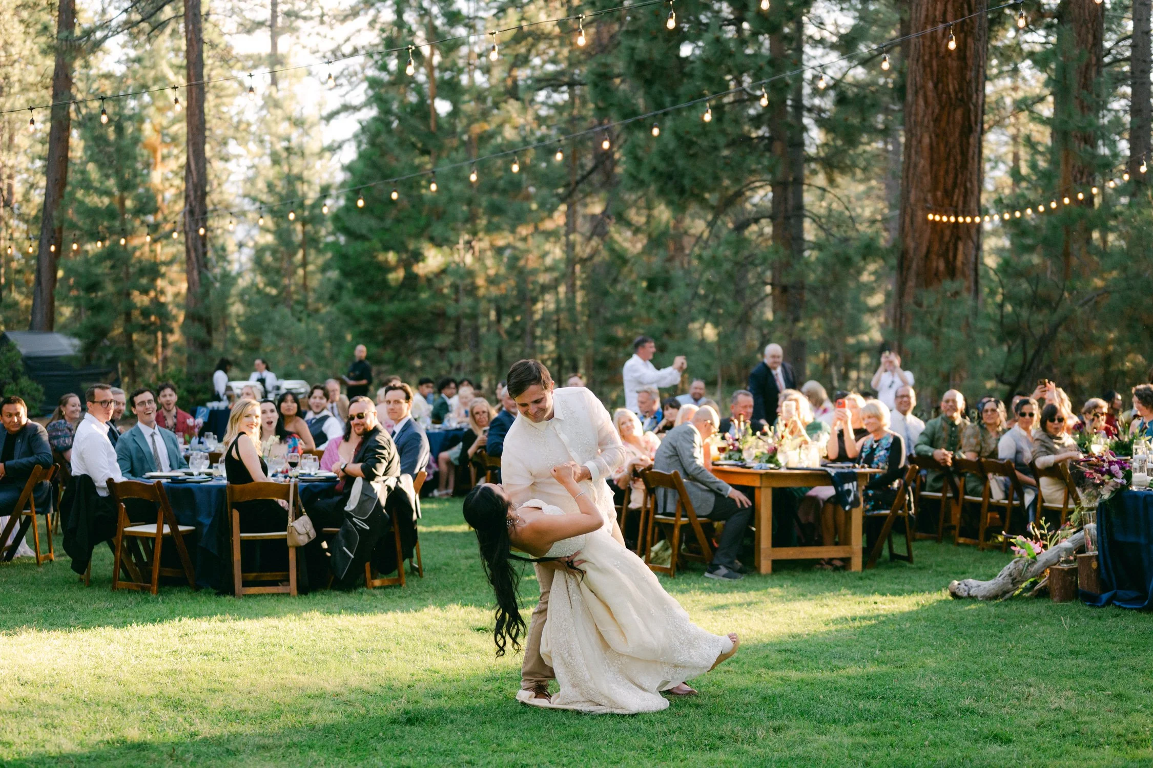 A Valhalla Lake Tahoe Wedding, photo of an outdoor wedding reception where a couple shares a dance on the lawn.
