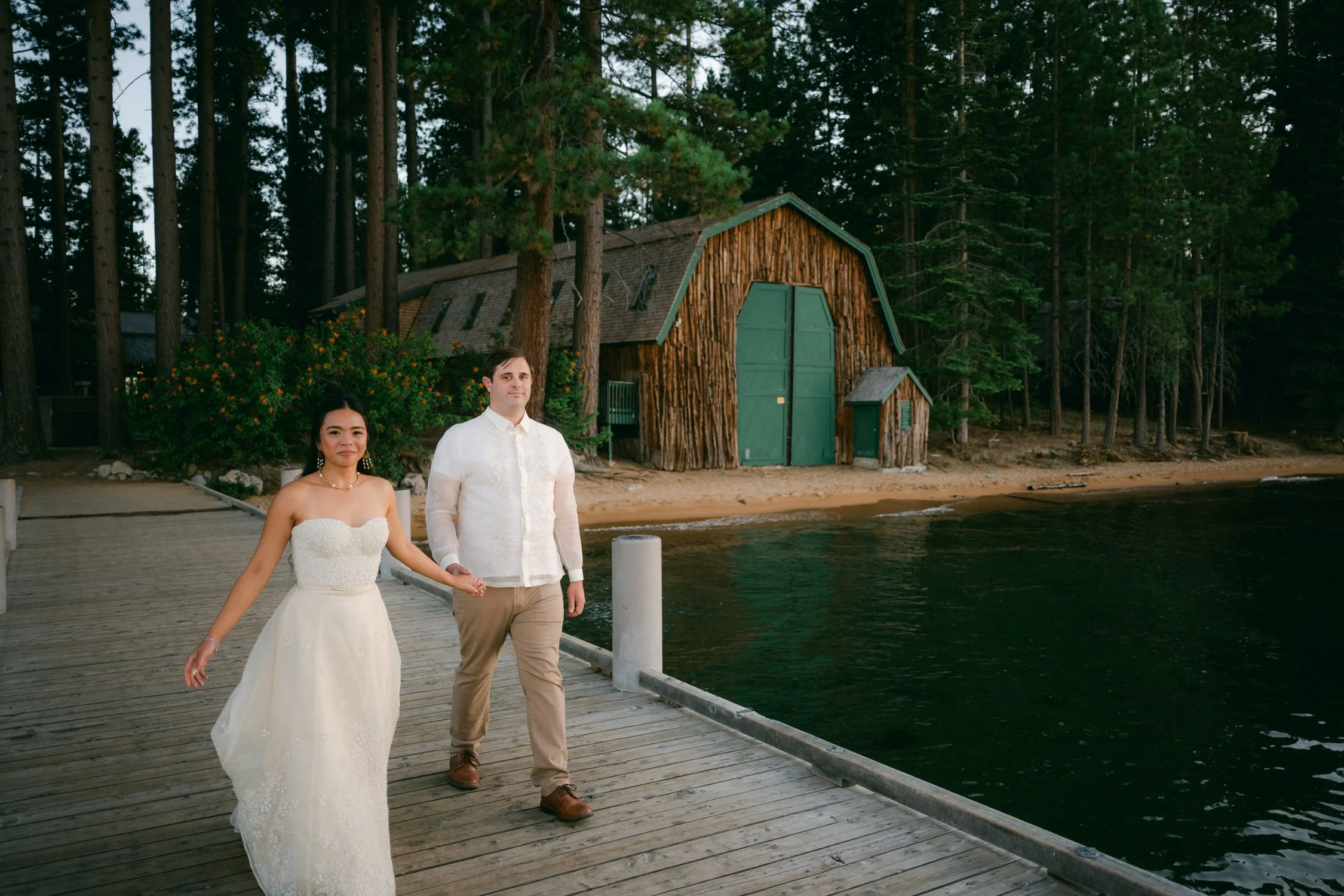 A Valhalla Lake Tahoe Wedding, photo of the newlyweds walking on a wooden pier on the shores of Lake Tahoe, California