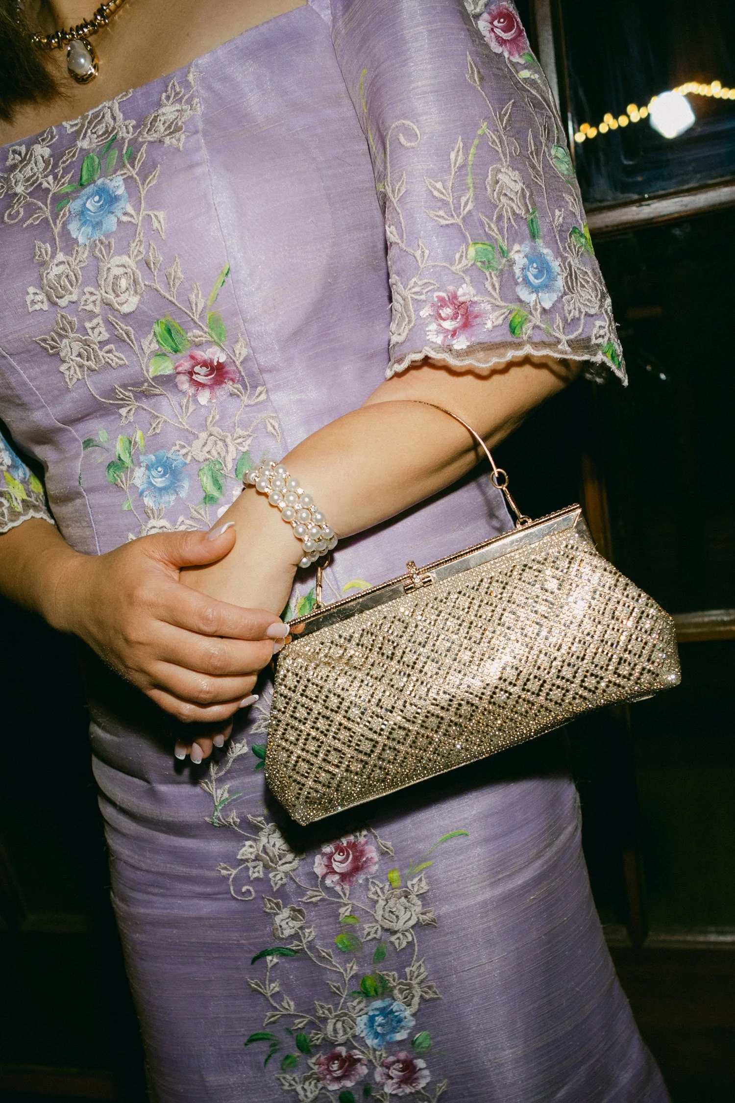 A Valhalla Lake Tahoe Wedding, photo of traditional Filipiniana dress adorned with delicate floral embroidery, paired with a sparkling gold frame clutch