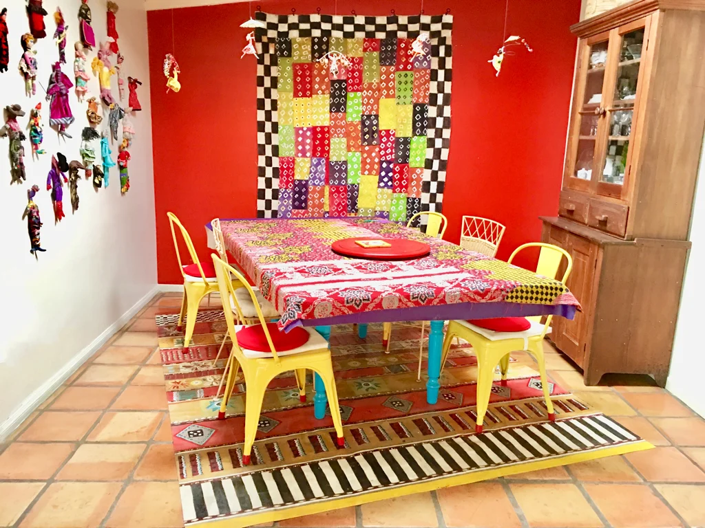The large wall hanging and floorcloth are commissioned pieces, a wonderful example of mixing and matching to create a unique look.