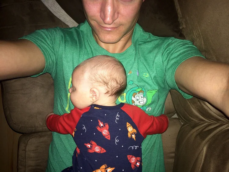 A warm little hot water bottle asleep on pops.