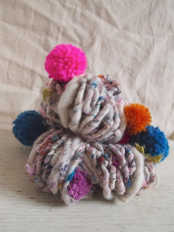 Handspun recycled silk yarn with pompoms