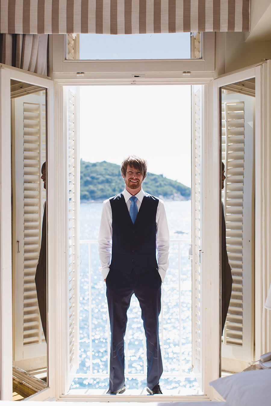 One of a set of images taken at this chic destination Wedding of Jenna & Nick. The stylish old town of Dubrovnik, Croatia.  The Groom stands with the sea in the background.Photography by Matt Porteous