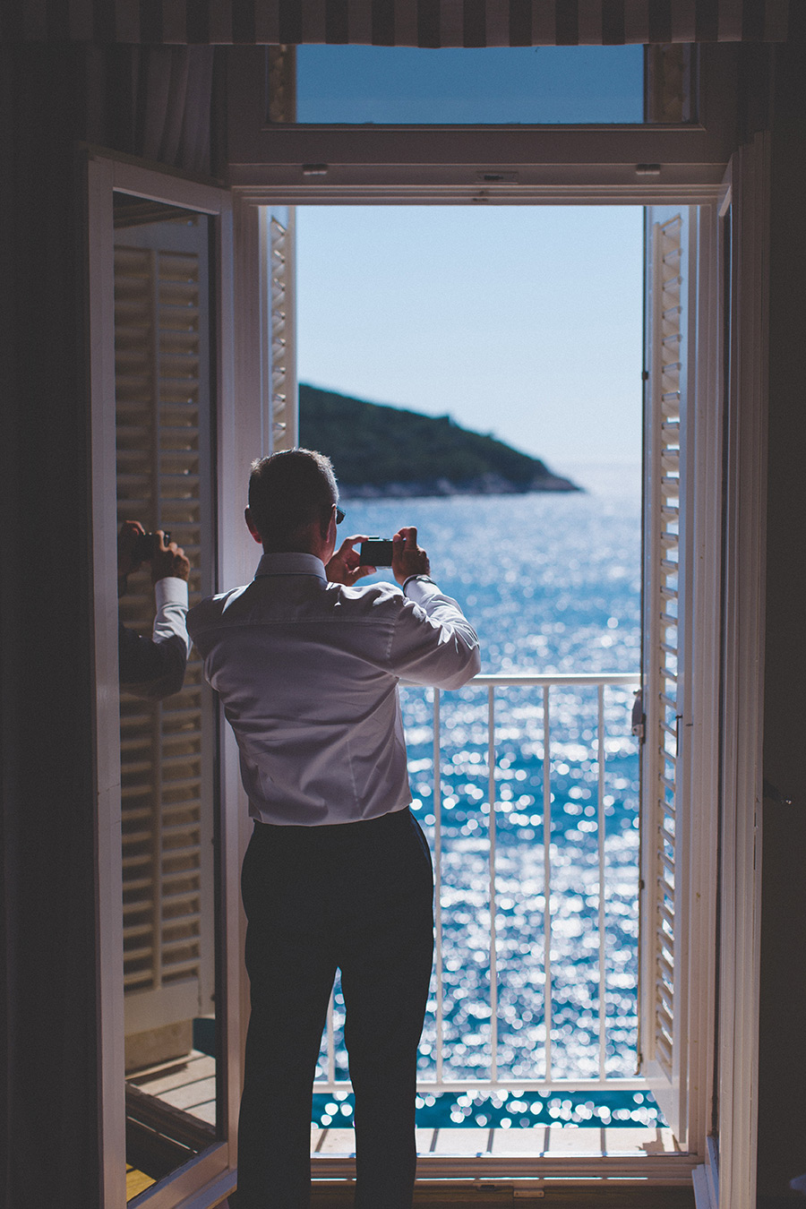 One of a set of images taken at this chic destination Wedding of Jenna & Nick. The stylish old town of Dubrovnik, Croatia.  The bright sun hitting the blue ocean.  Photography by Matt Porteous