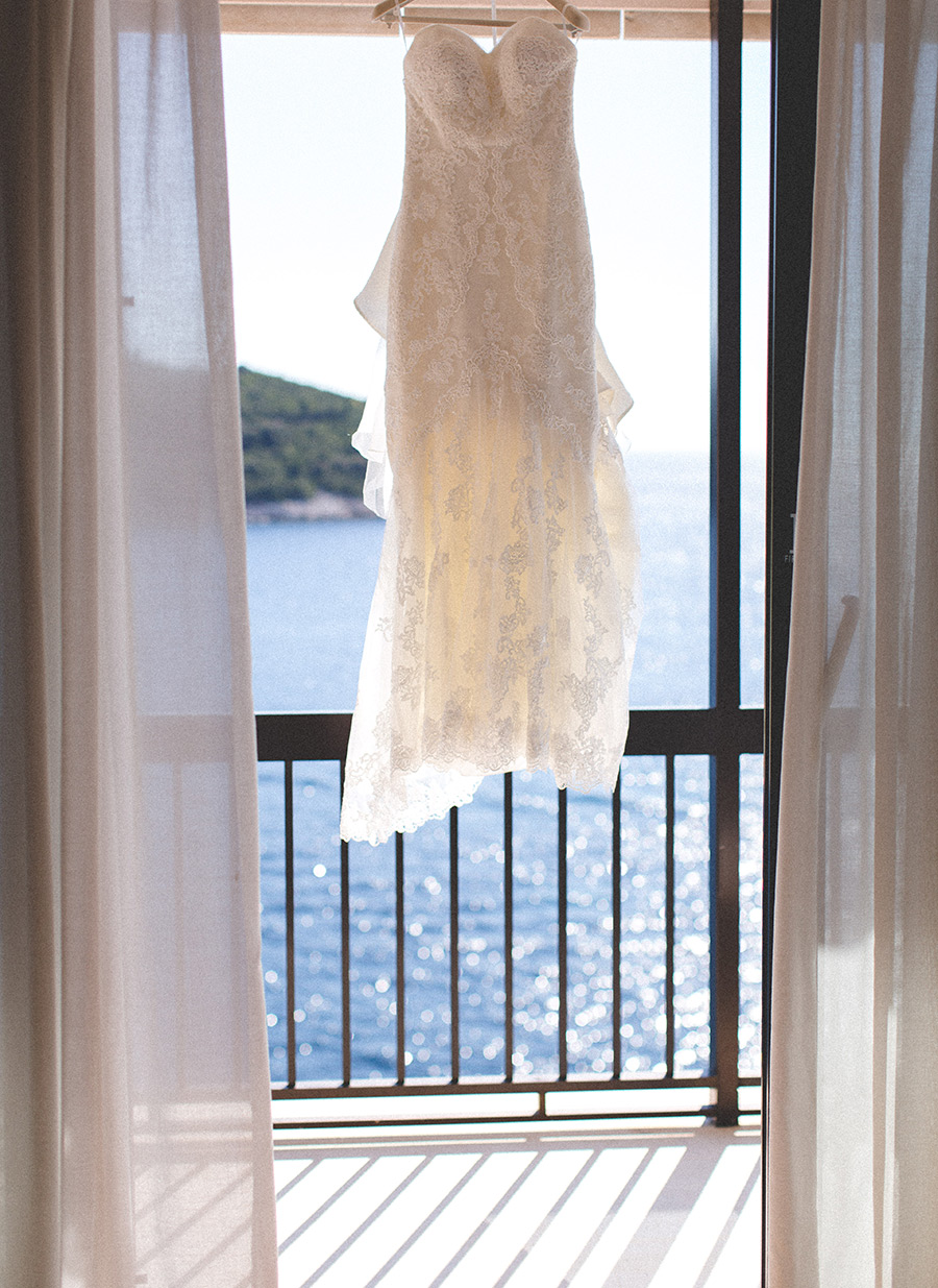One of a set of images taken at this chic destination Wedding of Jenna & Nick. The stylish old town of Dubrovnik, Croatia.  The Wedding dress blows in the wind.  Photography by Matt Porteous