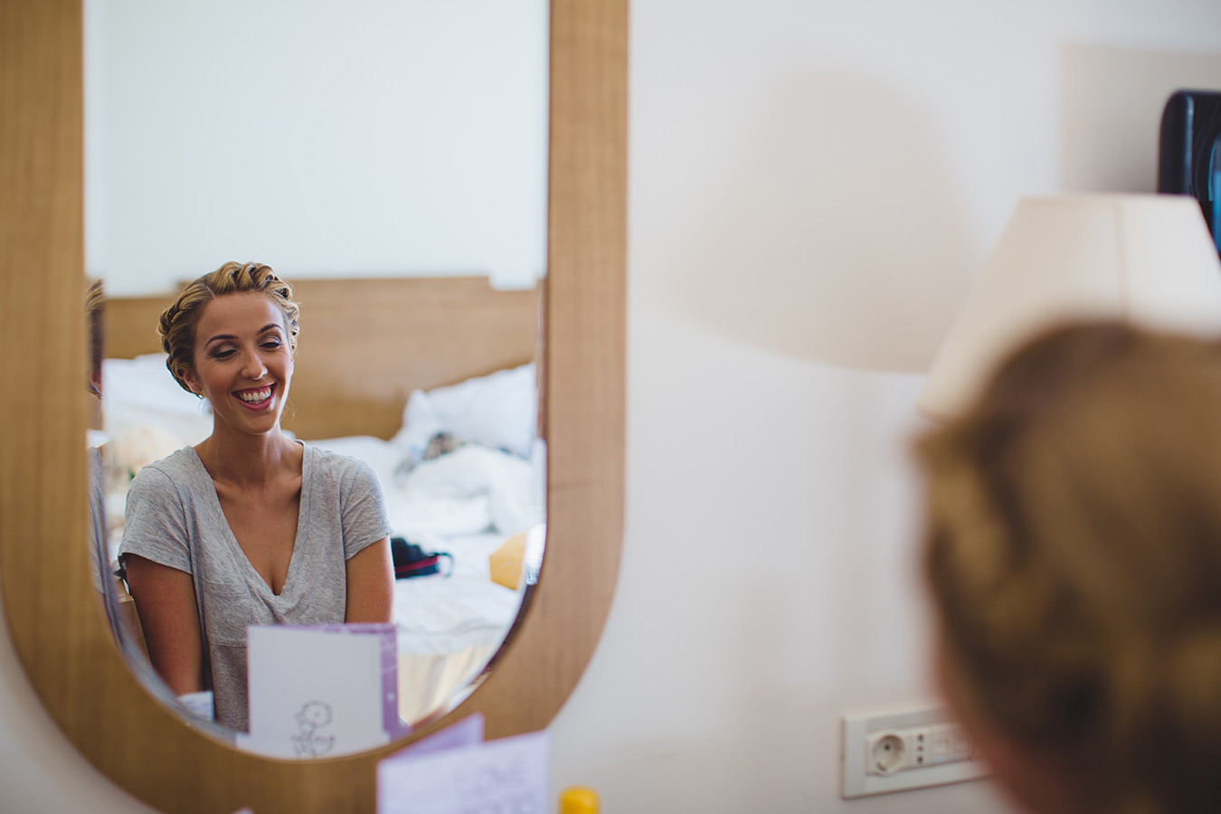 One of a set of images taken at this chic destination Wedding of Jenna & Nick. The stylish old town of Dubrovnik, Croatia.  The Bride sits at the mirror.  Photography by Matt Porteous