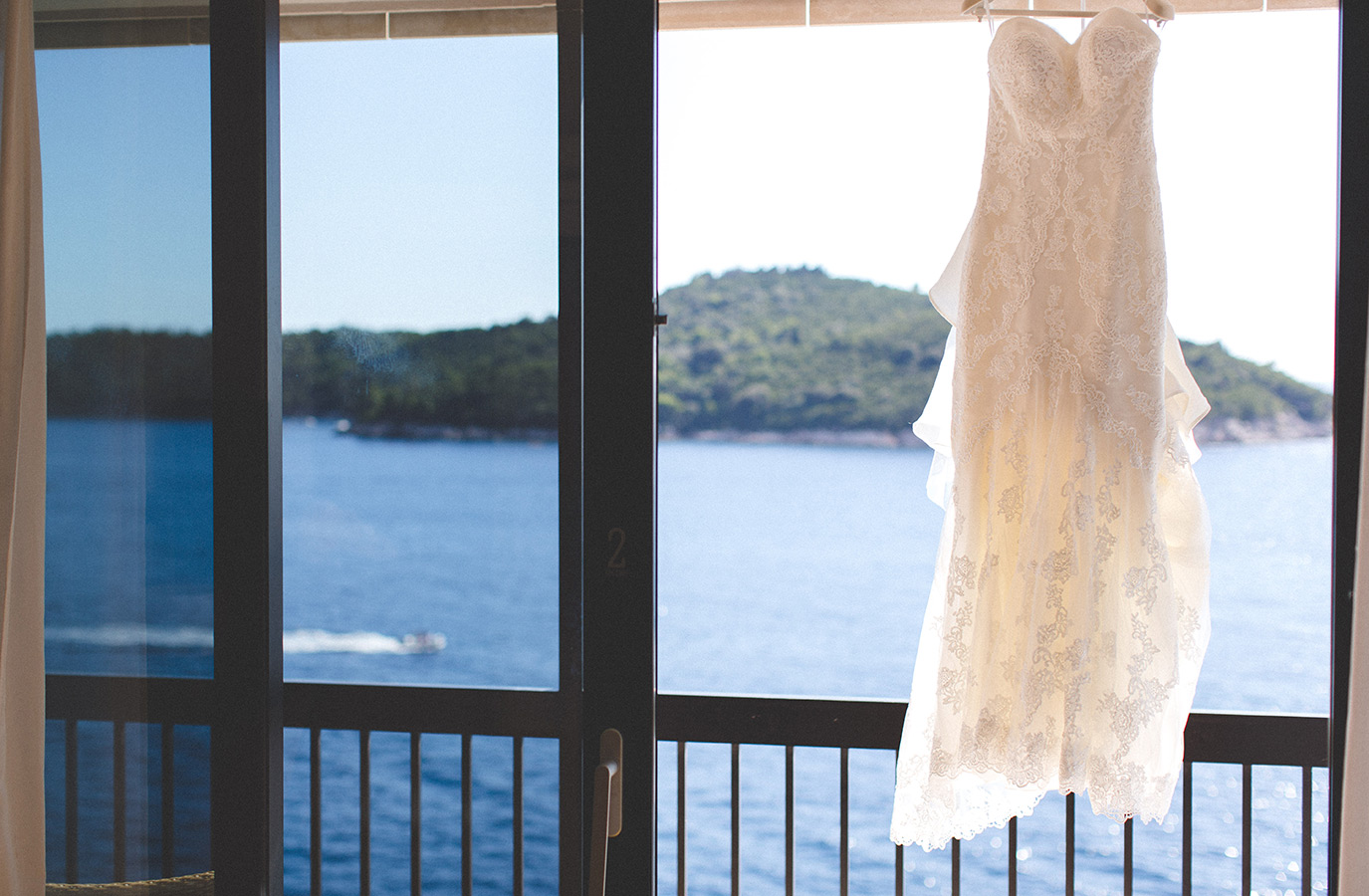 One of a set of images taken at this chic destination Wedding of Jenna & Nick. The stylish old town of Dubrovnik, Croatia.  The Wedding dress blows in the wind.  Photography by Matt Porteous