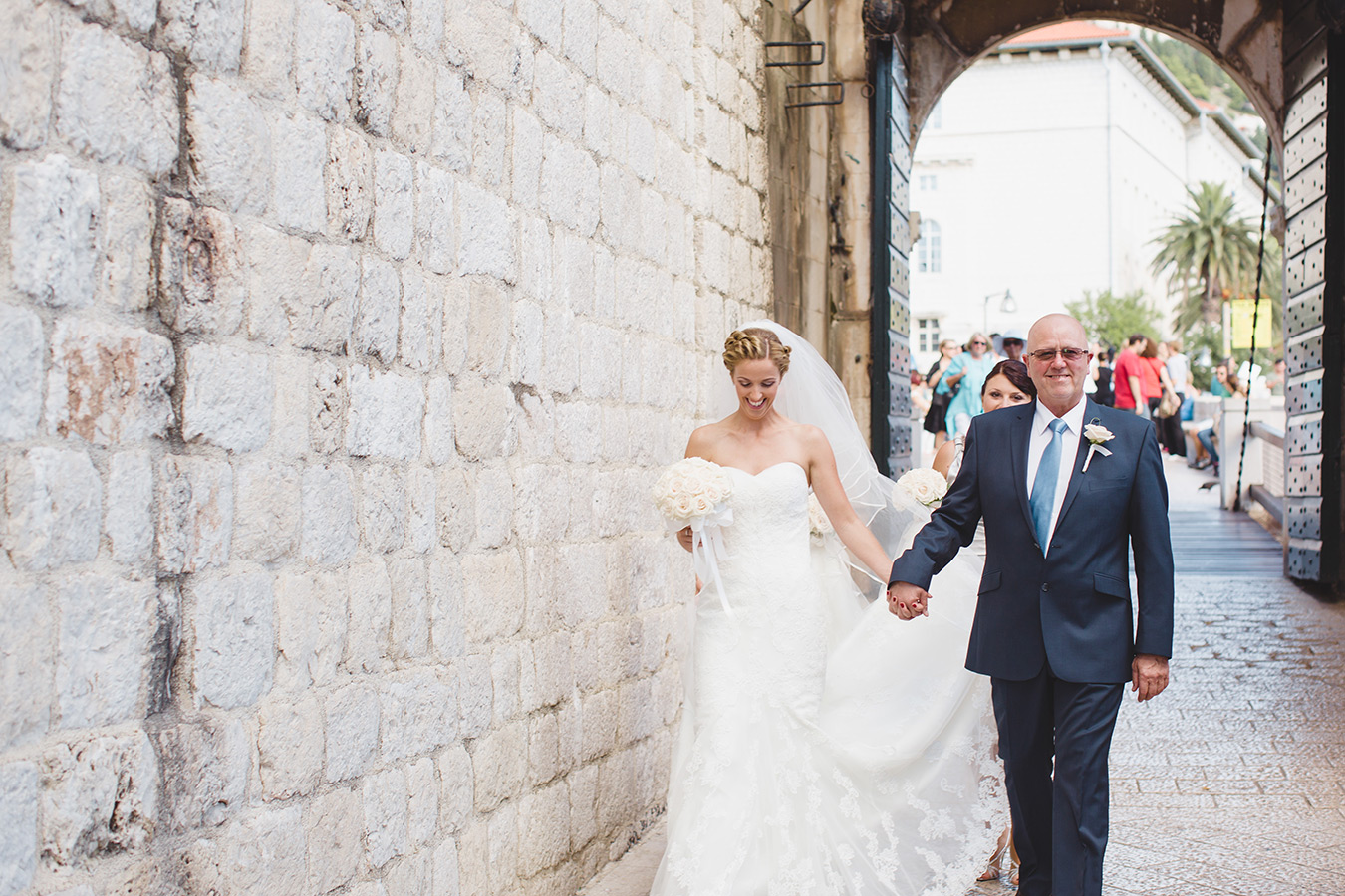 One of a set of images taken at this chic destination Wedding of Jenna & Nick. The stylish old town of Dubrovnik, Croatia.  The father of the Bride walks with his daughter.Photography by Matt Porteous