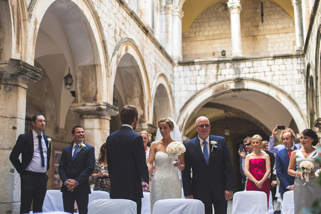 One of a set of images taken at this chic destination Wedding of Jenna & Nick. The stylish old town of Dubrovnik, Croatia.  The Congregation await.  Photography by Matt Porteous