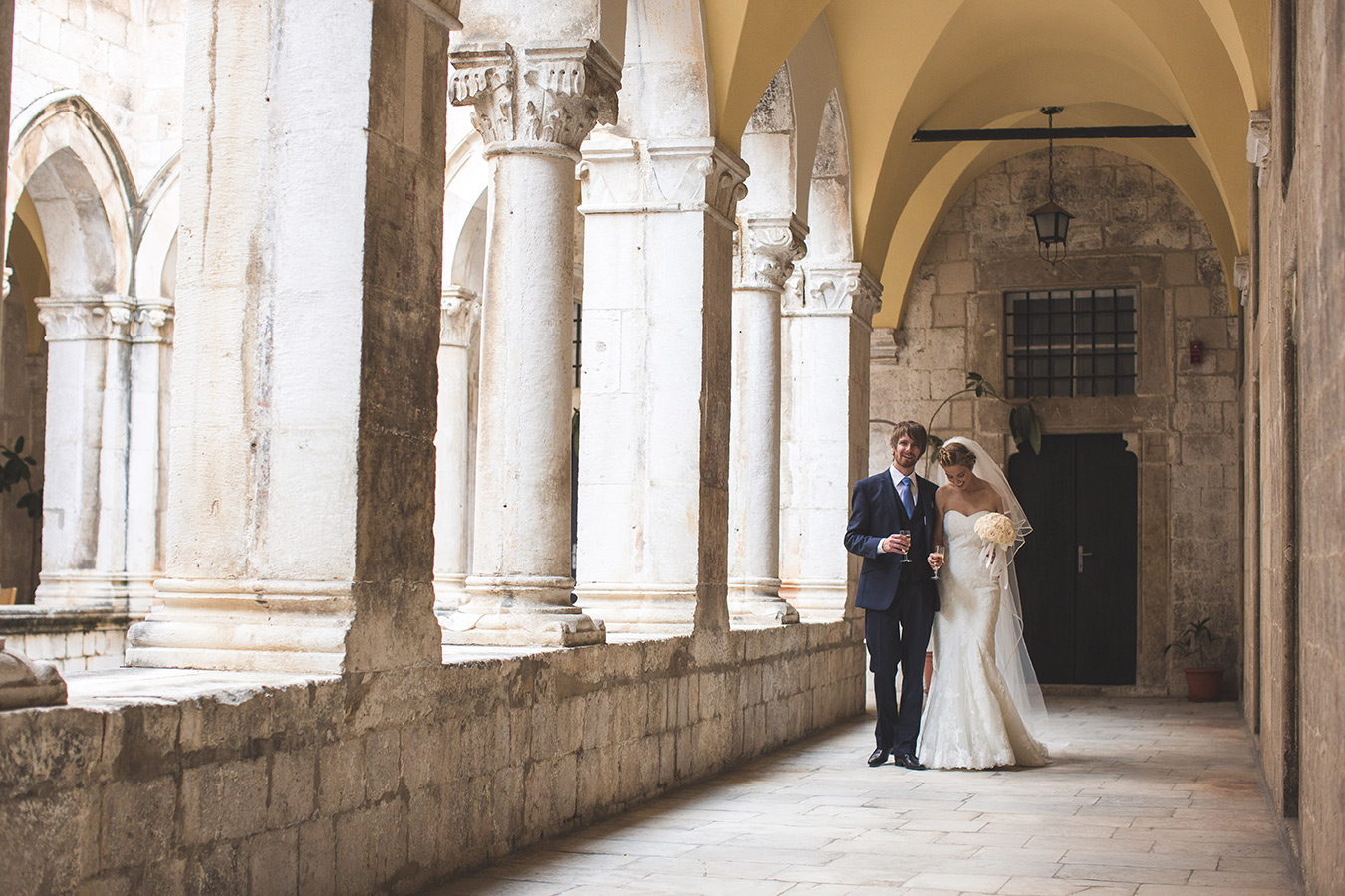One of a set of images taken at this chic destination Wedding of Jenna & Nick. The stylish old town of Dubrovnik, Croatia.  The couple walk hand in hand.  photography by Matt Porteous