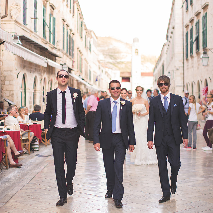 One of a set of images taken at this chic destination Wedding of Jenna & Nick. The stylish old town of Dubrovnik, Croatia.  The men in navy blue.  Photography by Matt Porteous.