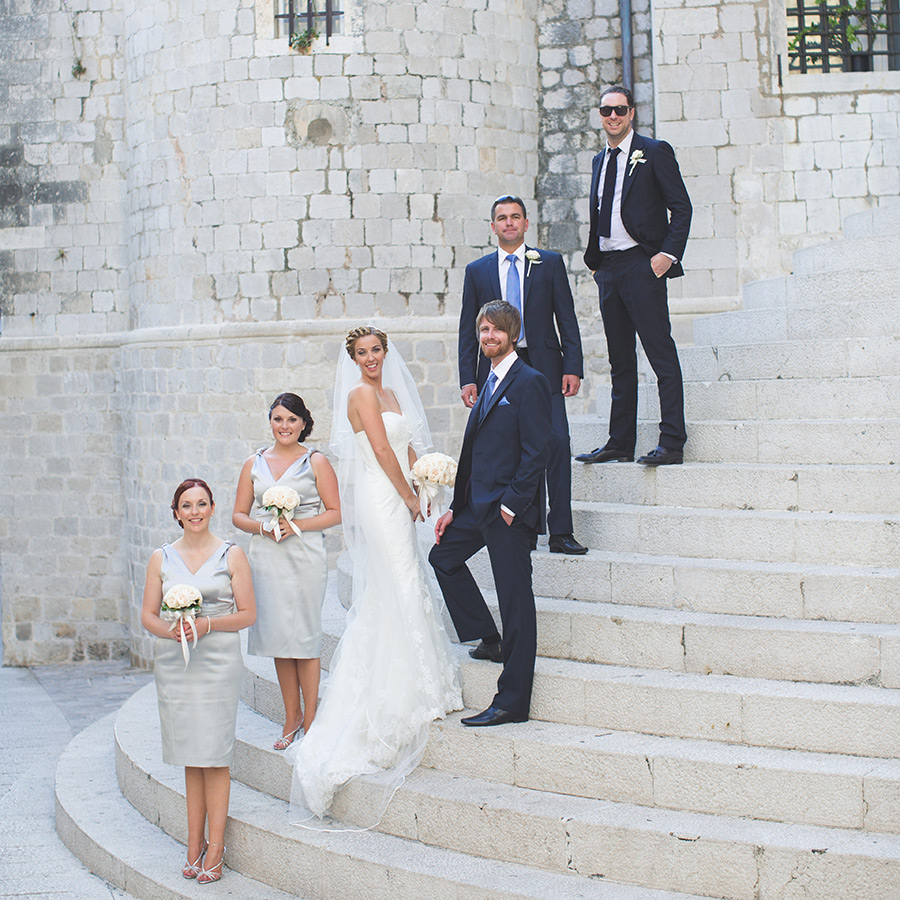 One of a set of images taken at this chic destination Wedding of Jenna & Nick. The stylish old town of Dubrovnik, Croatia.  The Bridal party & Groomsmen pose on the stairs.Photography by Matt Porteous