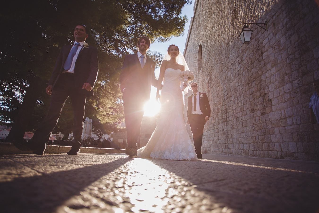 One of a set of images taken at this chic destination Wedding of Jenna & Nick. The stylish old town of Dubrovnik, Croatia.  The couple walk in the sunset.  Photography by Matt Porteous