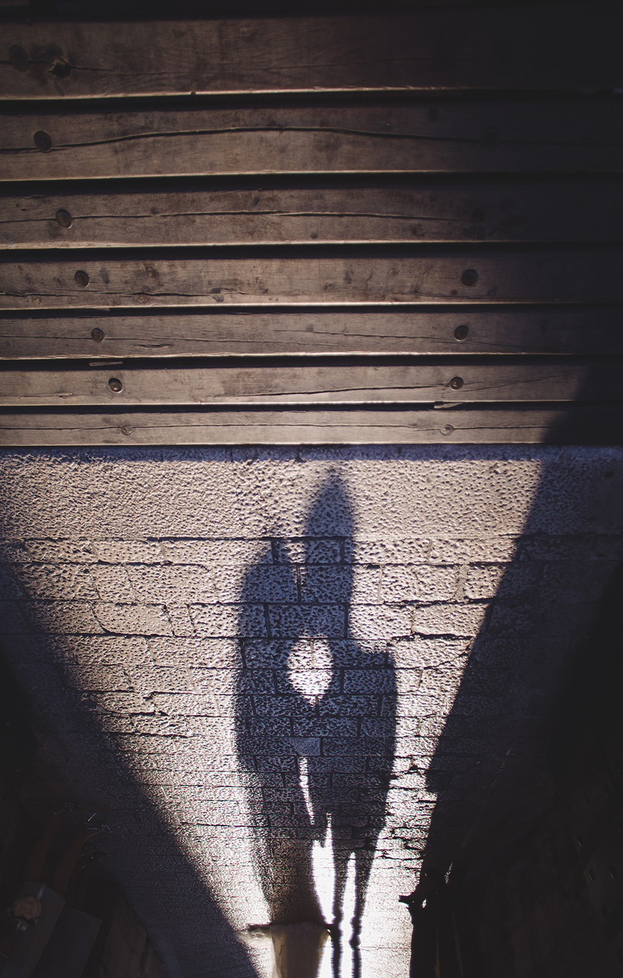 One of a set of images taken at this chic destination Wedding of Jenna & Nick. The stylish old town of Dubrovnik, Croatia.  The shadow of the couple in the sunset.  Photography by Matt Porteous