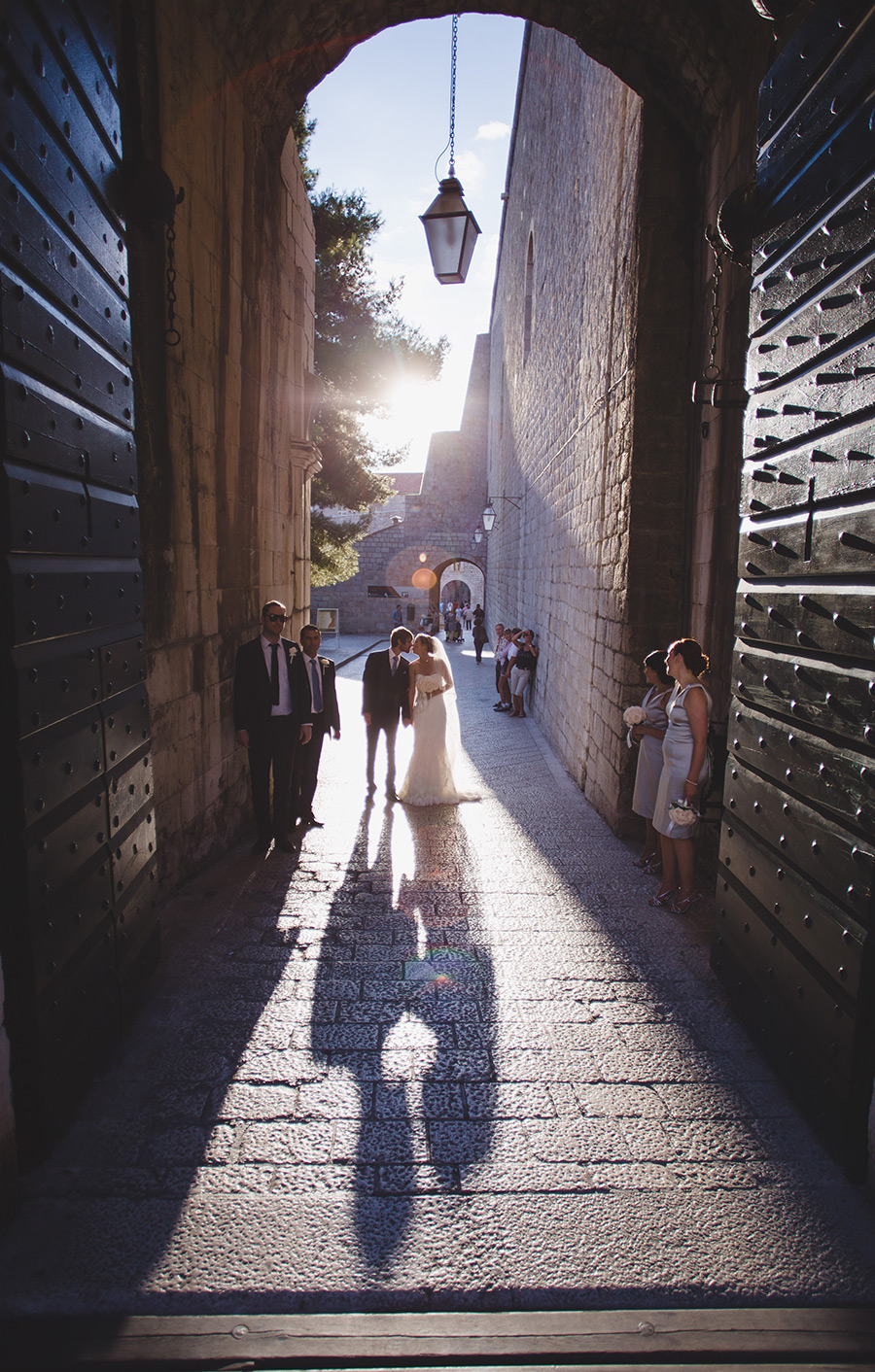 One of a set of images taken at this chic destination Wedding of Jenna & Nick. The stylish old town of Dubrovnik, Croatia.  The couple kiss in the sunset.  Photography by Matt Porteous