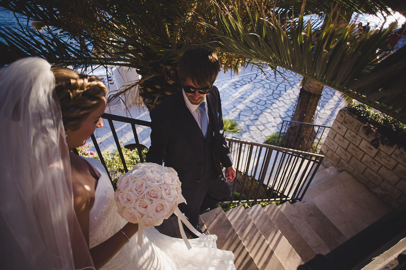One of a set of images taken at this chic destination Wedding of Jenna & Nick. The stylish old town of Dubrovnik, Croatia.  The Bride and Groom walk down the stairs. Photography by Matt Porteous