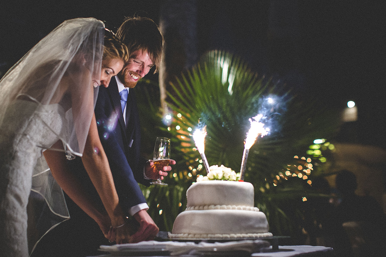 One of a set of images taken at this chic destination Wedding of Jenna & Nick. The stylish old town of Dubrovnik, Croatia.  The couple cut the cake.  Photography by Matt Porteous