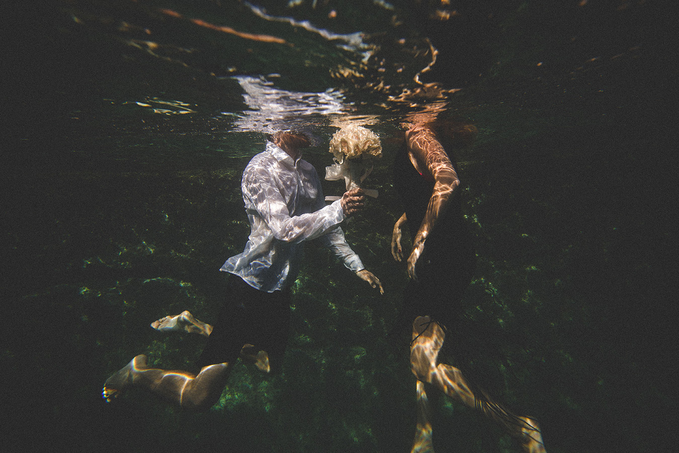 One of a set of images taken at this chic destination Wedding of Jenna & Nick. The stylish old town of Dubrovnik, Croatia.  Underwater image of the couple.  Photography by Matt Porteous