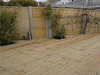 Garden patio with wooden decking fence enclosure.