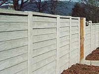 Tall fence with panels outside garden 