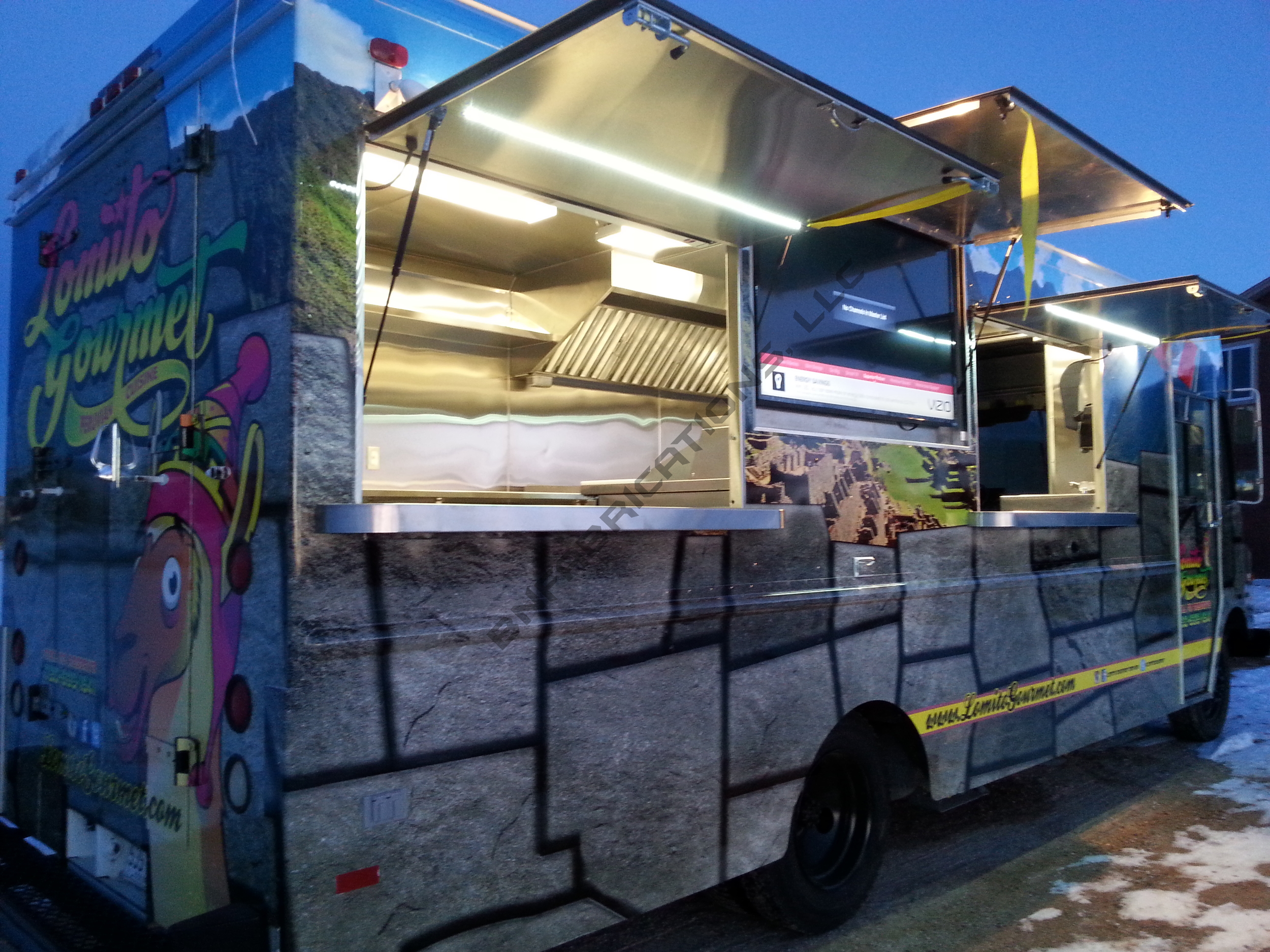 Lomito's food truck serving window and TV awnings